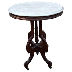 Late 19th Century Eastlake Style Walnut and Marble Tip Oval Rolling Side Table
