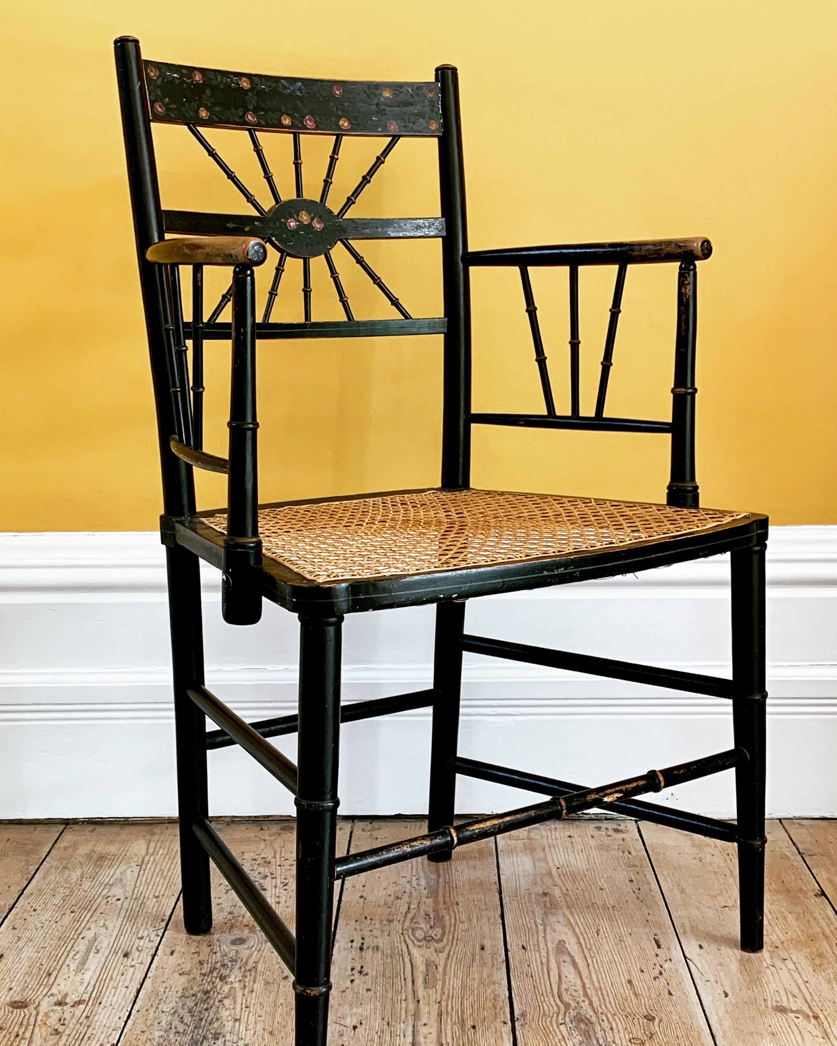 Original example Sussex chair with unusual design back with original painted design with flowers. The cane seat is undamaged.