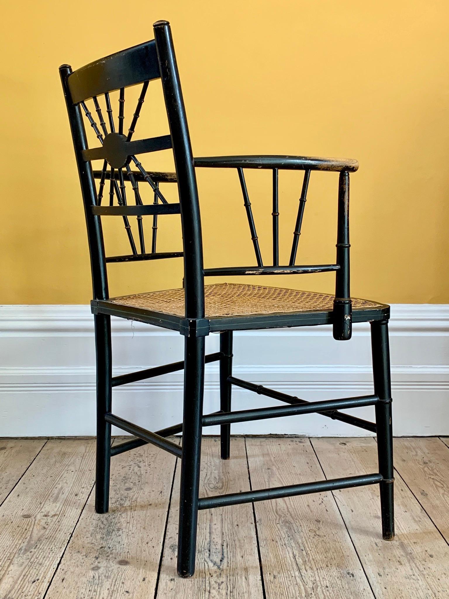 Aesthetic Movement Late 19th Century Ebonized Sussex Chair with Cane Seat and Painted Detail For Sale