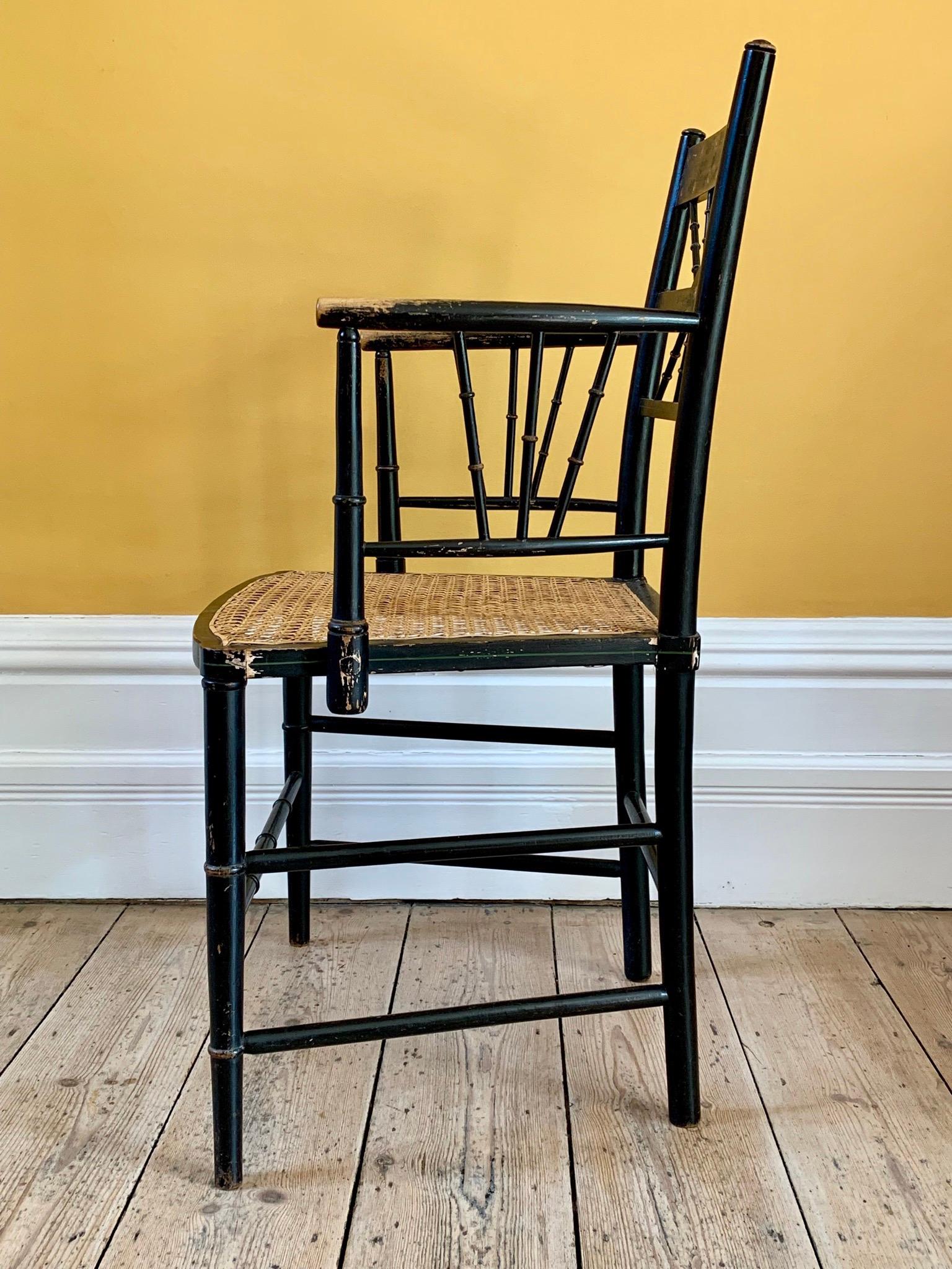 British Late 19th Century Ebonized Sussex Chair with Cane Seat and Painted Detail For Sale