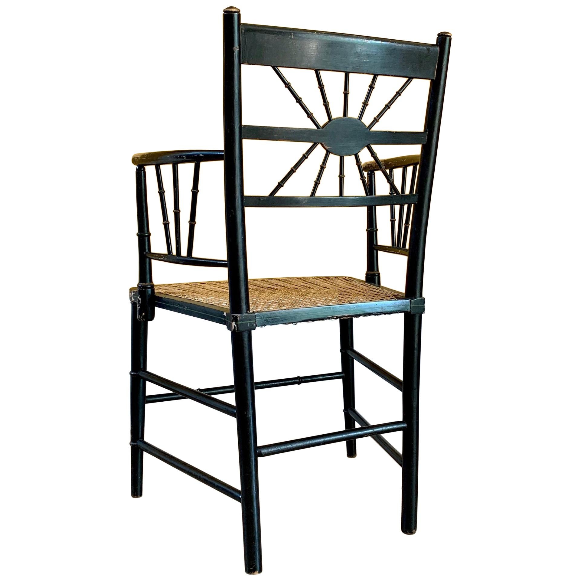 Late 19th Century Ebonized Sussex Chair with Cane Seat and Painted Detail For Sale