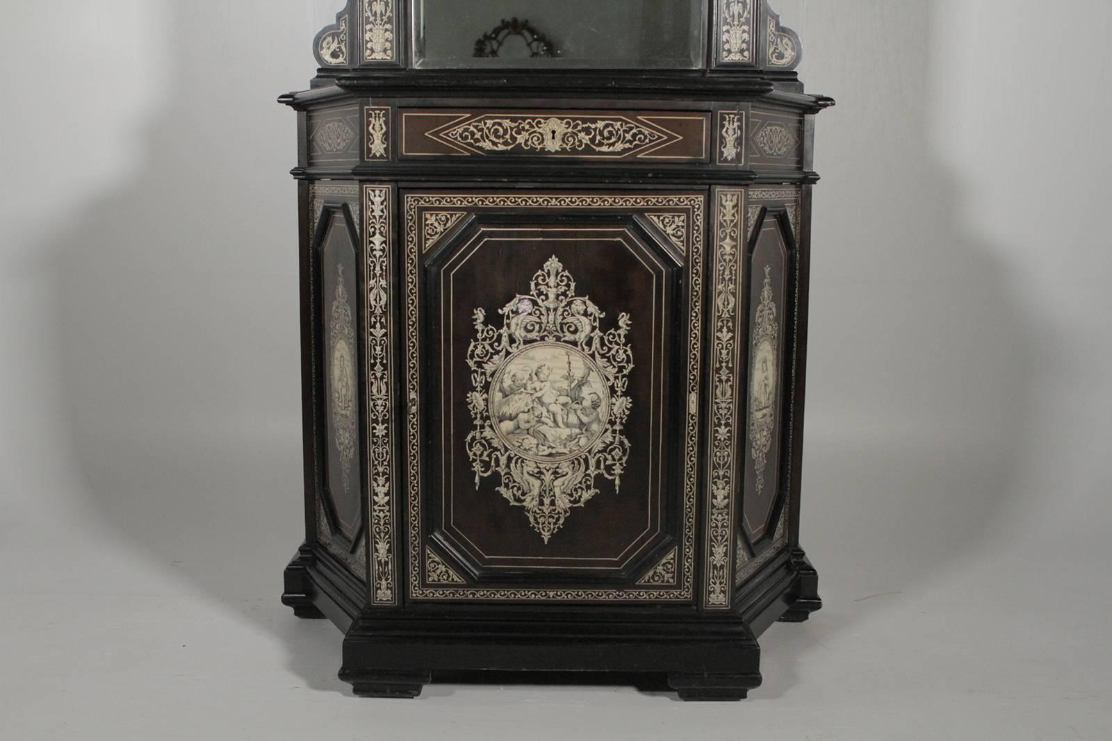 Late 19th century ebonized and inlaid cabinet with mirrored door. The top section with mirror the bottom with a cabinet doo that opens to reveal a single shelf. Impressive and elaborate inlay over ebony.