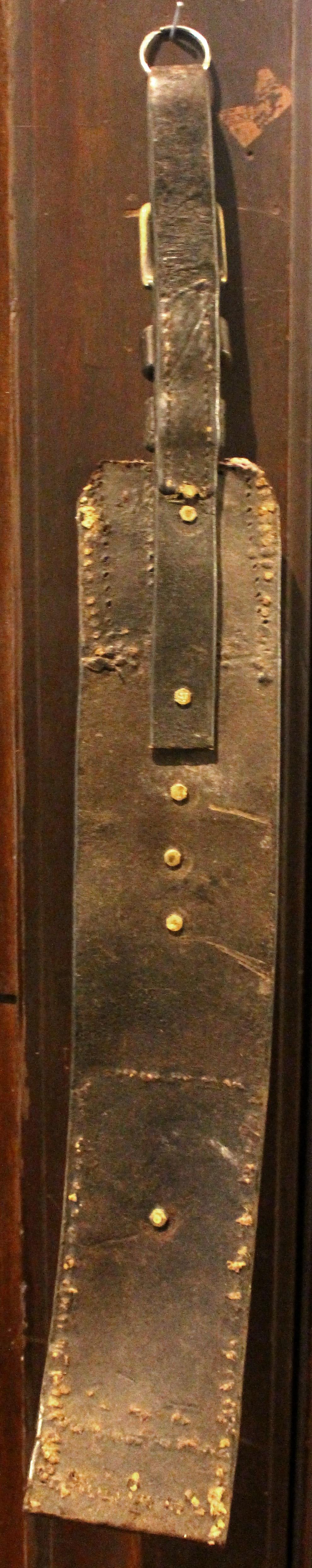Late 19th century English 3-brass long leather horse strap. Straight leather strap with tacks featuring brasses of a Rampant Lion Shield, Wheat Sheaf, & Plowman.
24.5