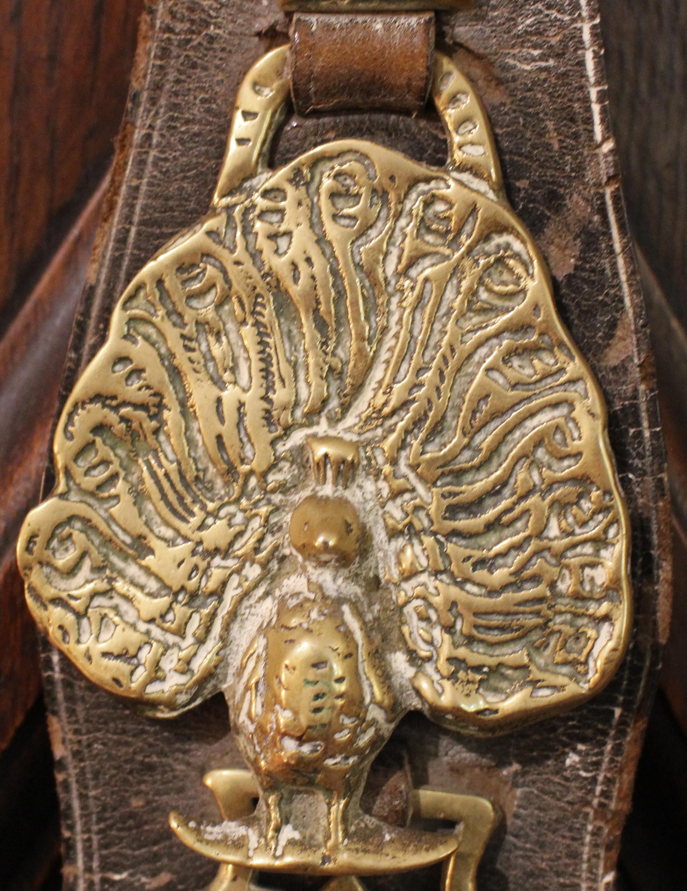 Late 19th century English 5-brass leather horse strap. Shaped leather featuring brasses of a Proud Peacock, Lion Rampant, Double Hump Camel, Wheat Sheaf, & Bird. 22 5/8