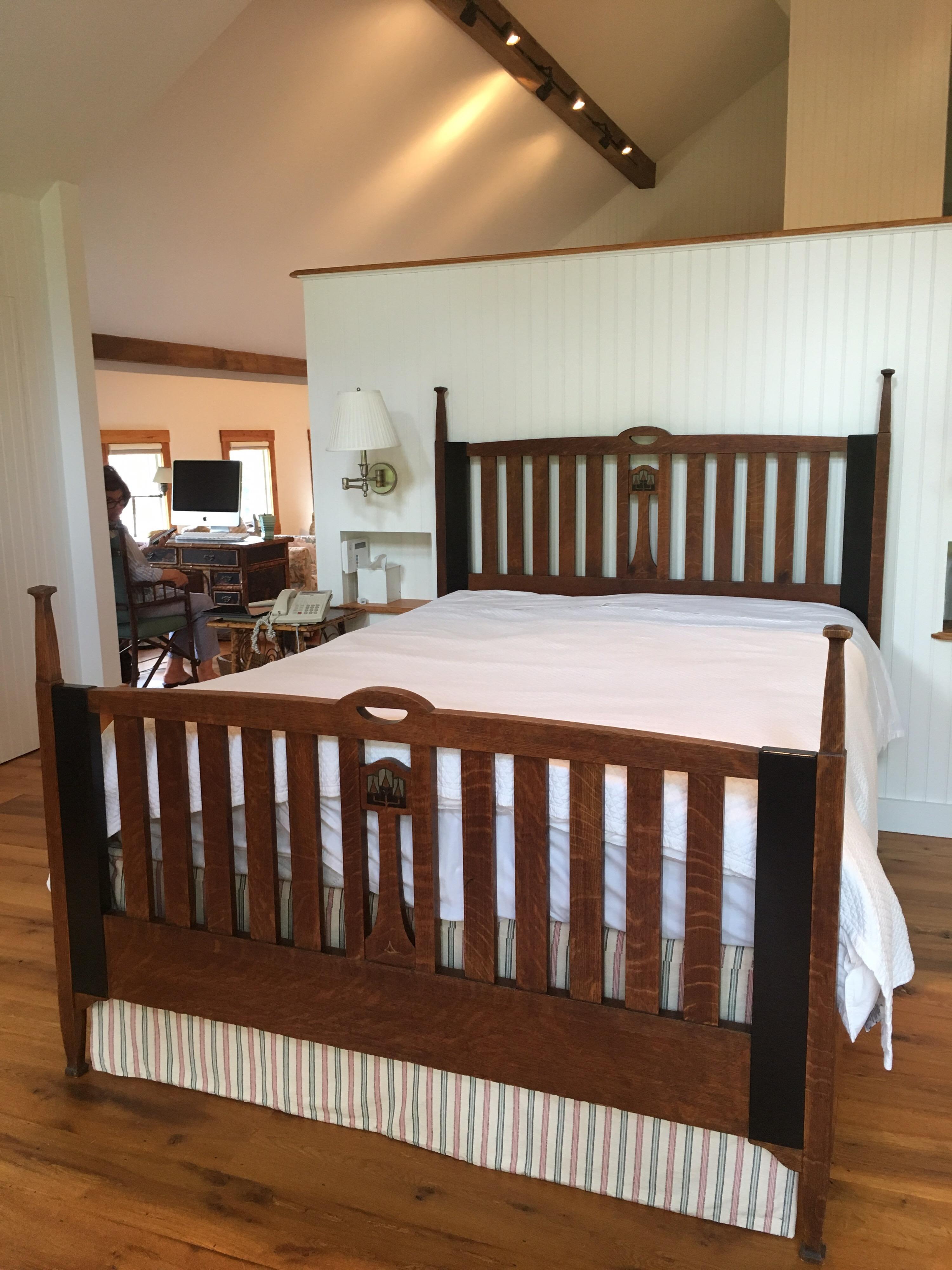 Late 19th-early 20th century English Arts & Crafts oak Queen bed frame with pewter inlay. A matching set including a full size Arts & Crafts bed which was converted to a Queen from a full size, made from solid oak, ebony and pewter. The two black