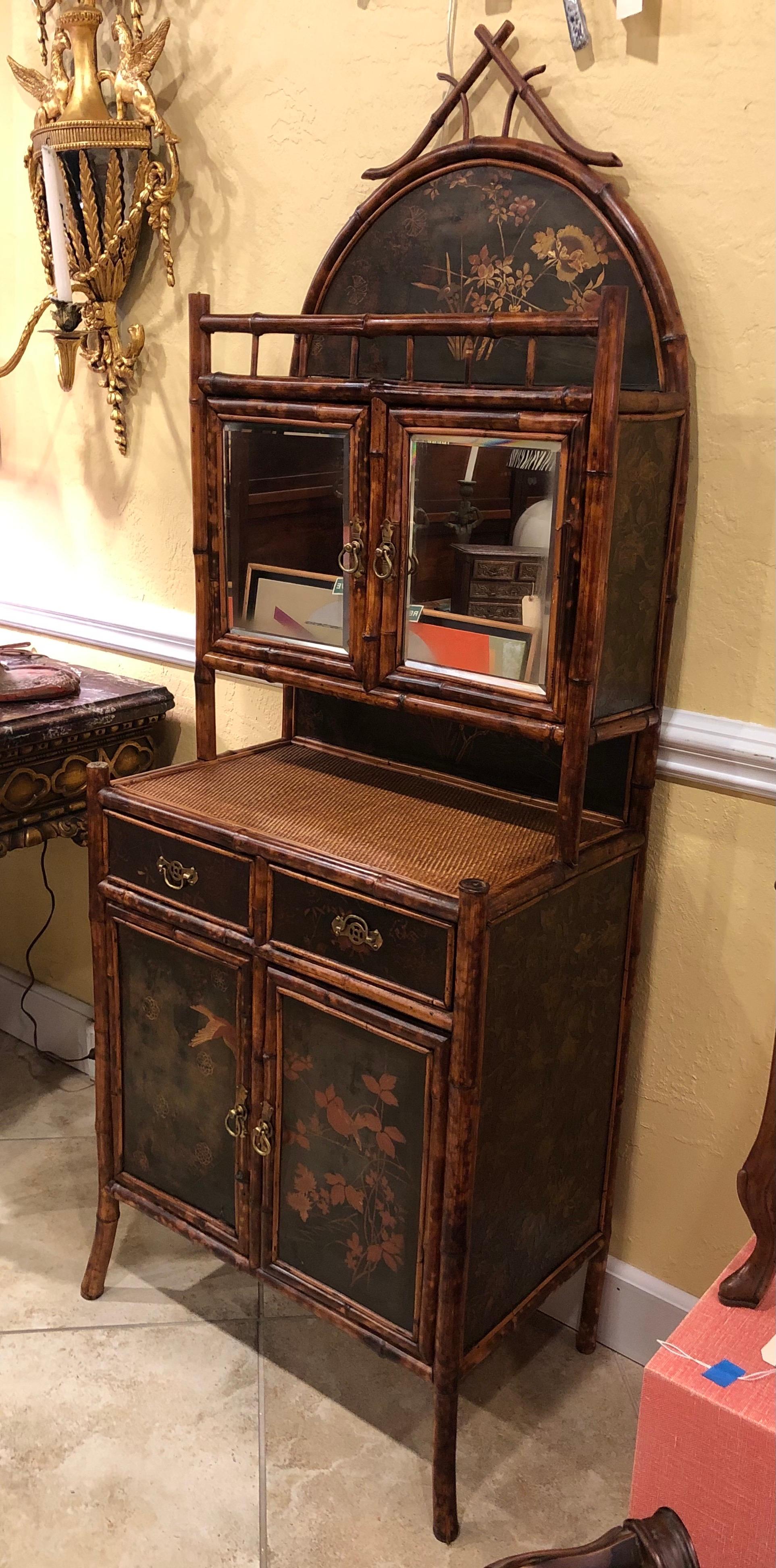 English bamboo lacquered cabinet with four doors and two drawers, circa 1880. Decorated with foliate and avian motif, and brass handles.