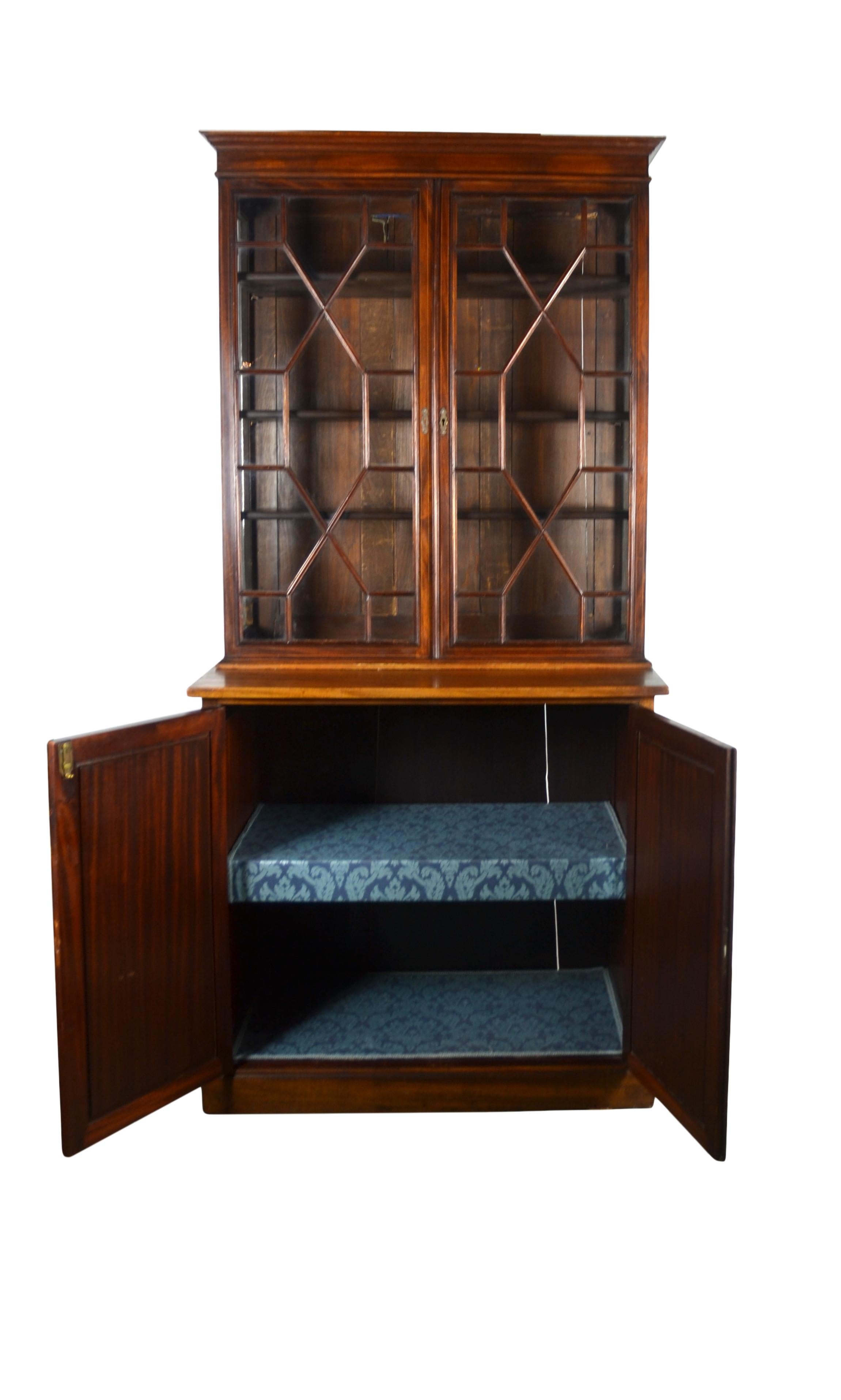 Late 19th-century mahogany two-part bookcase. Astragal glazing and string inlay to bookcase top.