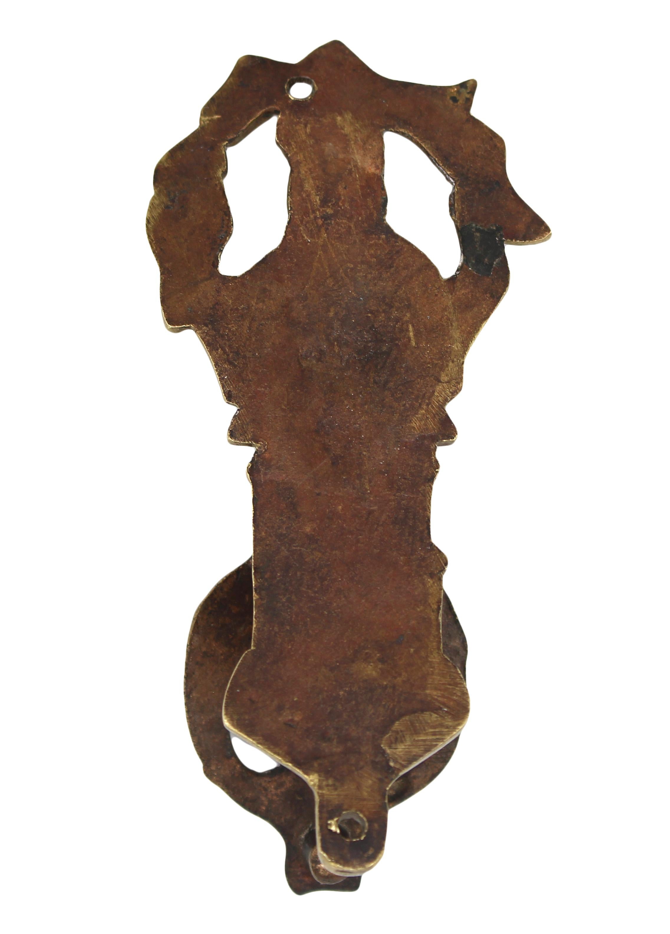 Late 19th century brass interior Charles Dickens door knocker, English. Featuring the author surrounded by some of his most beloved works - a few character adorn the knocker drop.
4 5/8