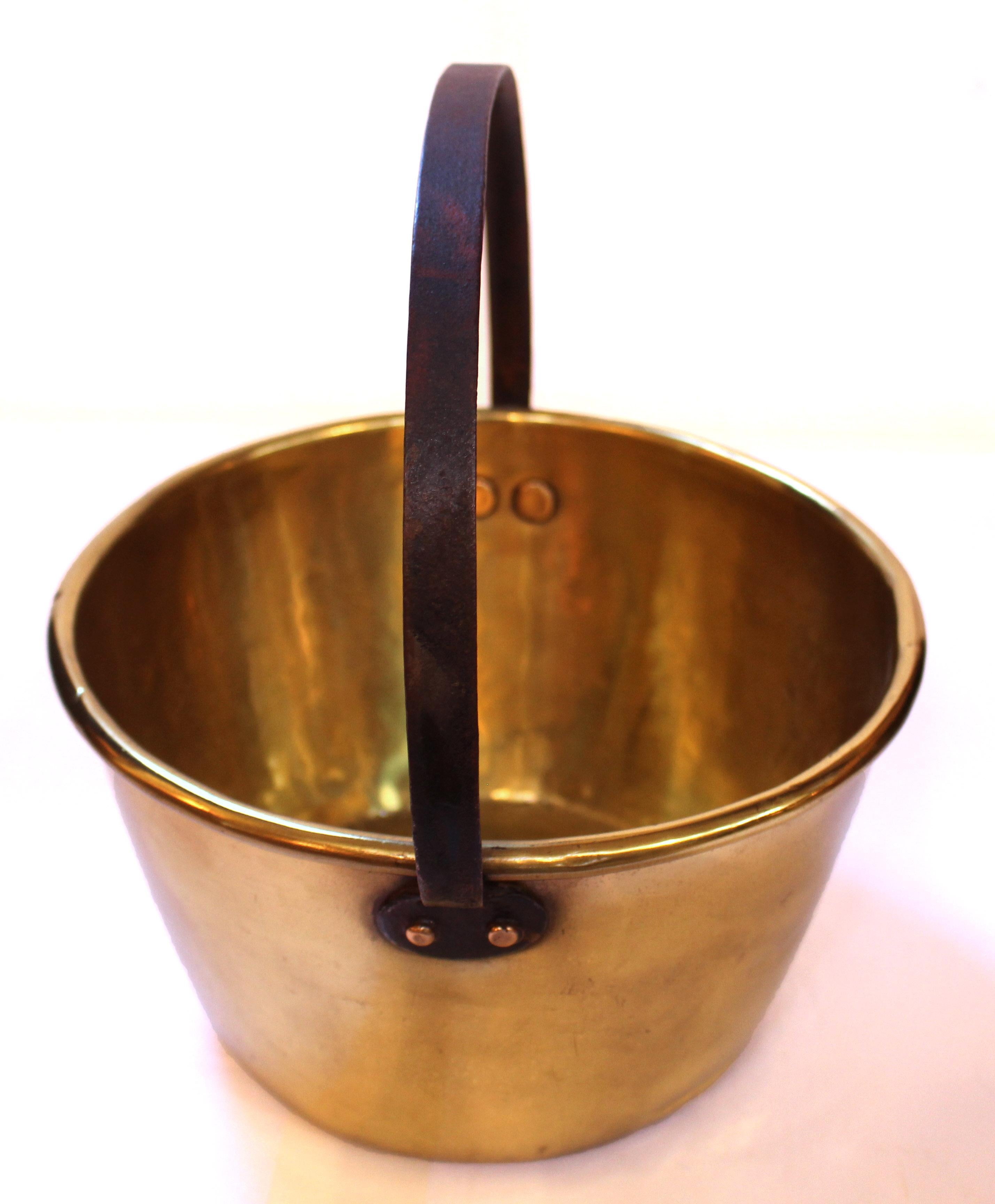 Late 19th century brass milk bucket, English. Brass riveted fixed position iron handle.
11 7/8