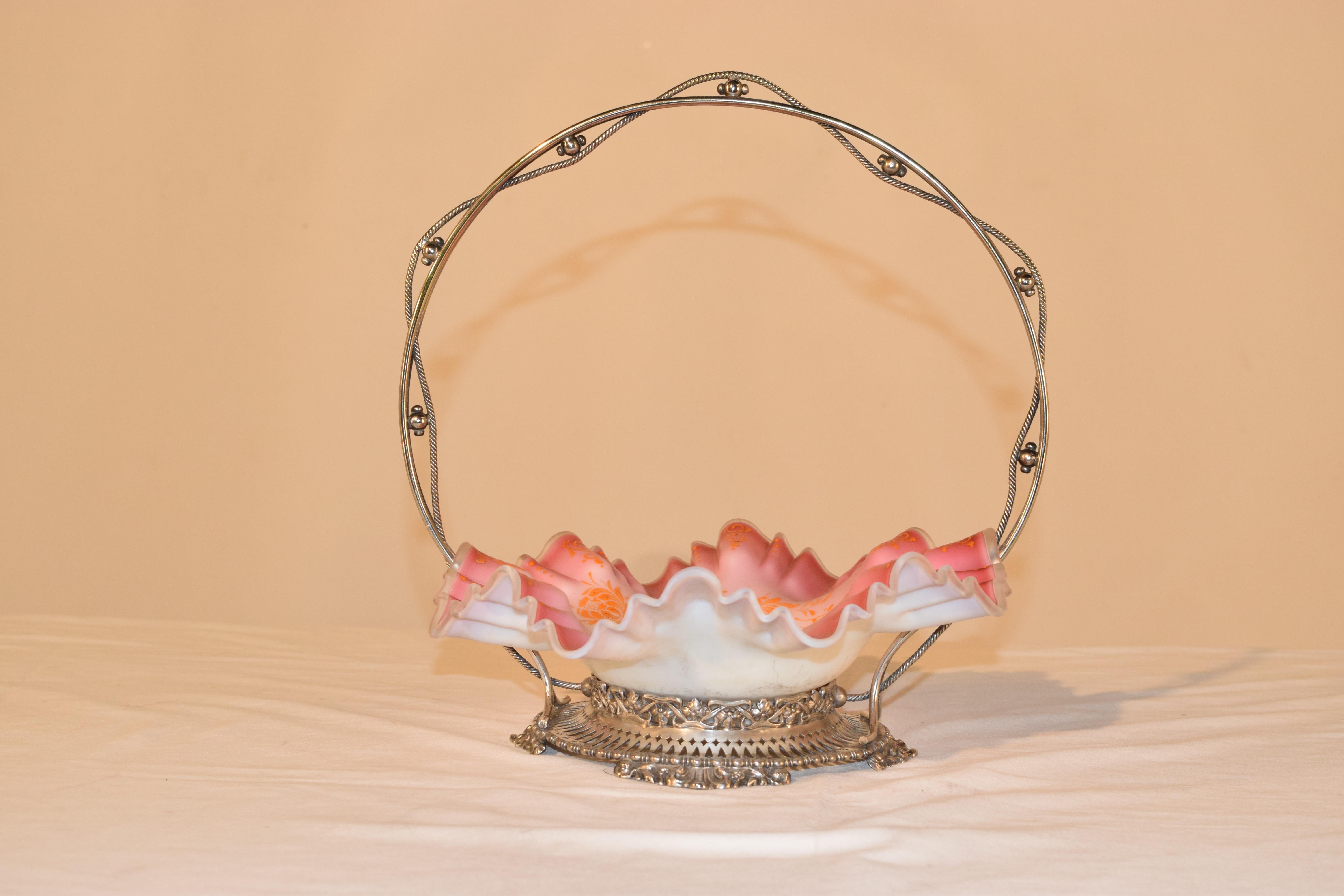 Late 19th century art glass cased bridal basket with pink and white satin glass bowl, which is shaped and fluted around the edge and is hand painted with orange florals. The bowl has a silver plate surround which is pierced around the base and a