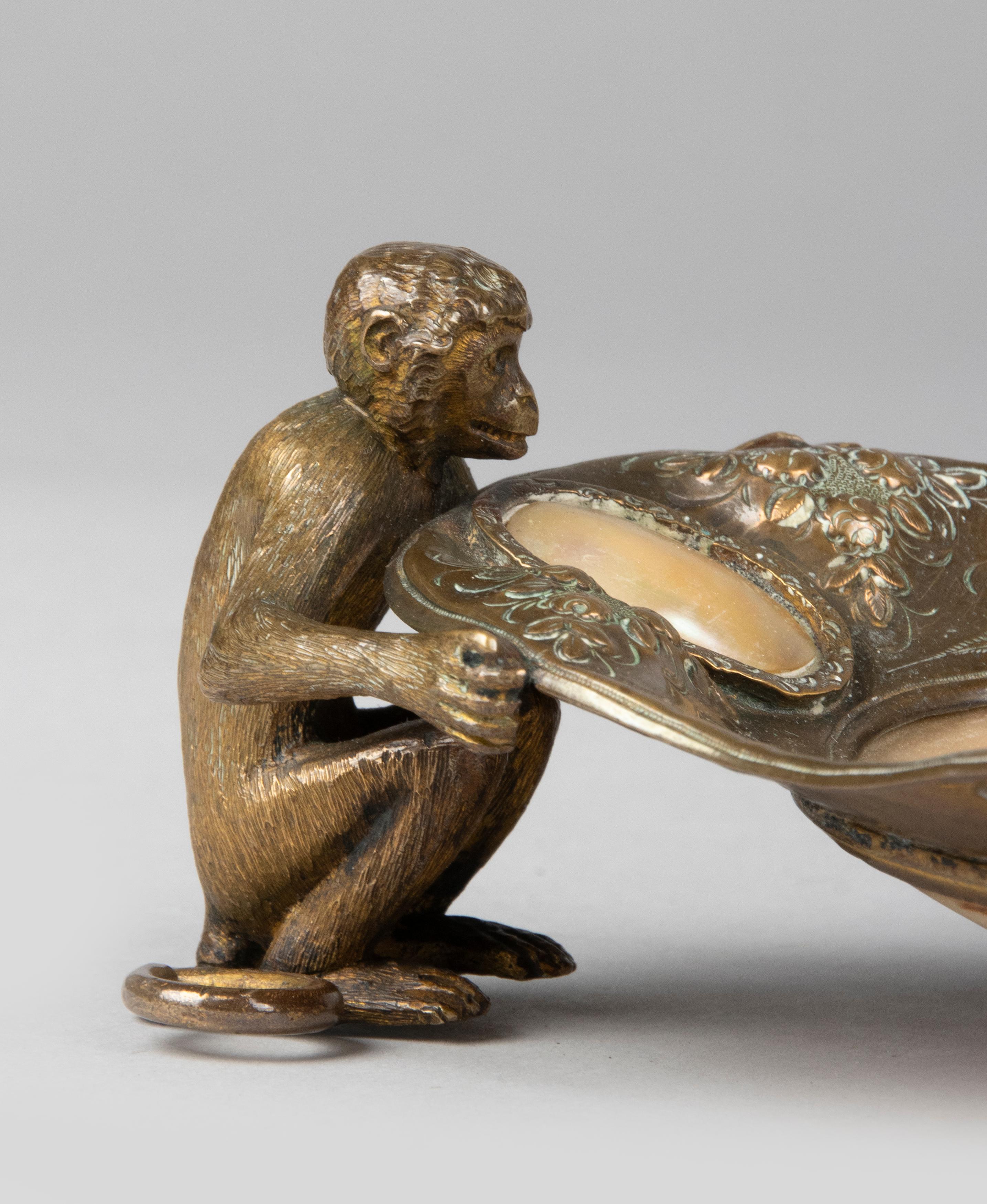 Special bronze vide poche depicting two monkeys holding a bowl. The object is made of fine bronze, hammered with beautiful patterns. The dish is inlaid with mother-of-pearl. Special decorative item with an animal theme. Nice old patina.
