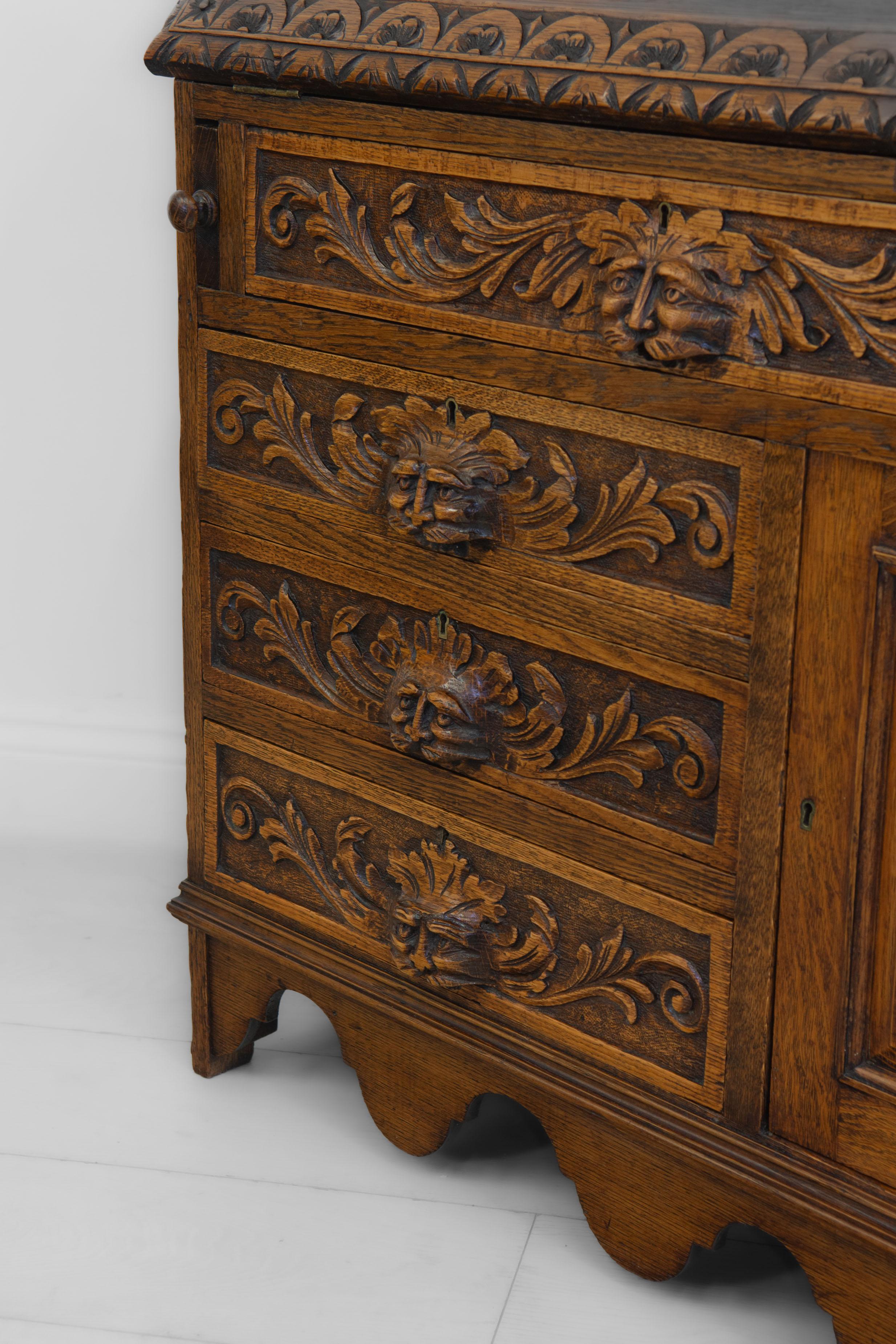 An antique English carved golden oak green man bureau/desk, circa 1890.

The bureau has a wonderful rich golden colour and has been sympathetically re-finished by hand in a shellac sealer. It has a smooth waxed finish, but still retains a few