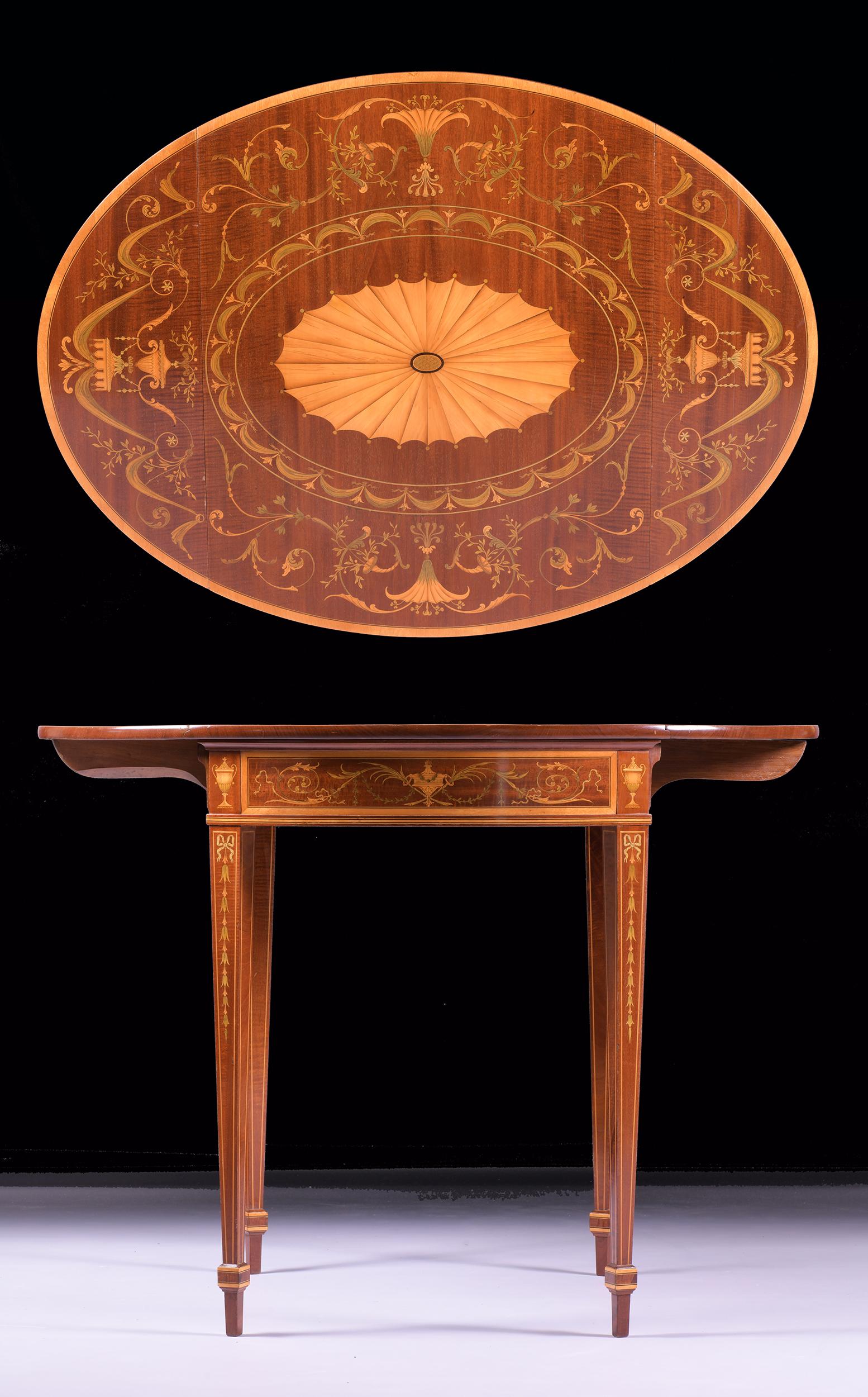 An exceptional late 19th early 20th century satinwood pembroke table by Edwards & Roberts, of oval form with twin drop leaves, the top with central oval banded fanning patera within radiating border of inlaid garlands, above a single frieze drawer