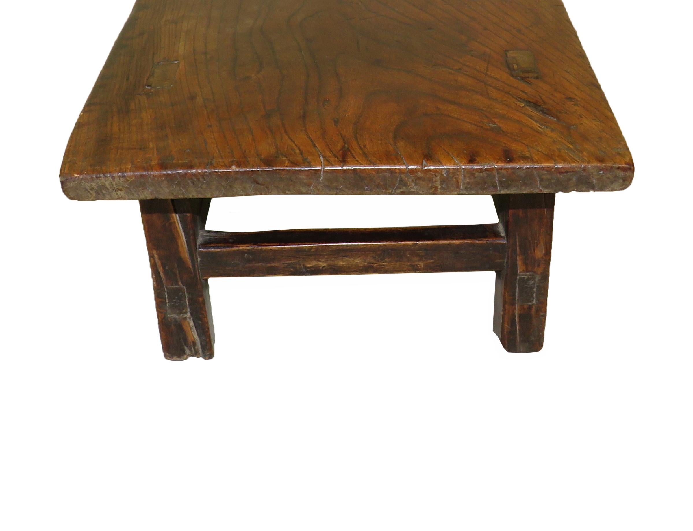 A charming late 19th century English elm
coffee table having superbly figured top
retaining exceptional color and patina
raised on square legs and stretchers.
 