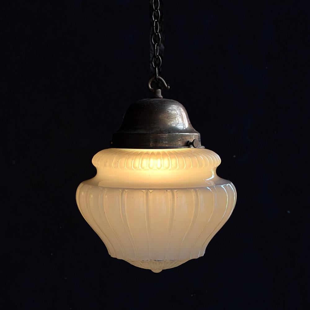 Pharmacy Light 

We are proud to offer a late-19th Century English fluted opaque moonstone glass shade. Supported by a metal gallery with a wonderful untouched patina. The moonstone shade boasts a robust natural yet delicate appearance and emits