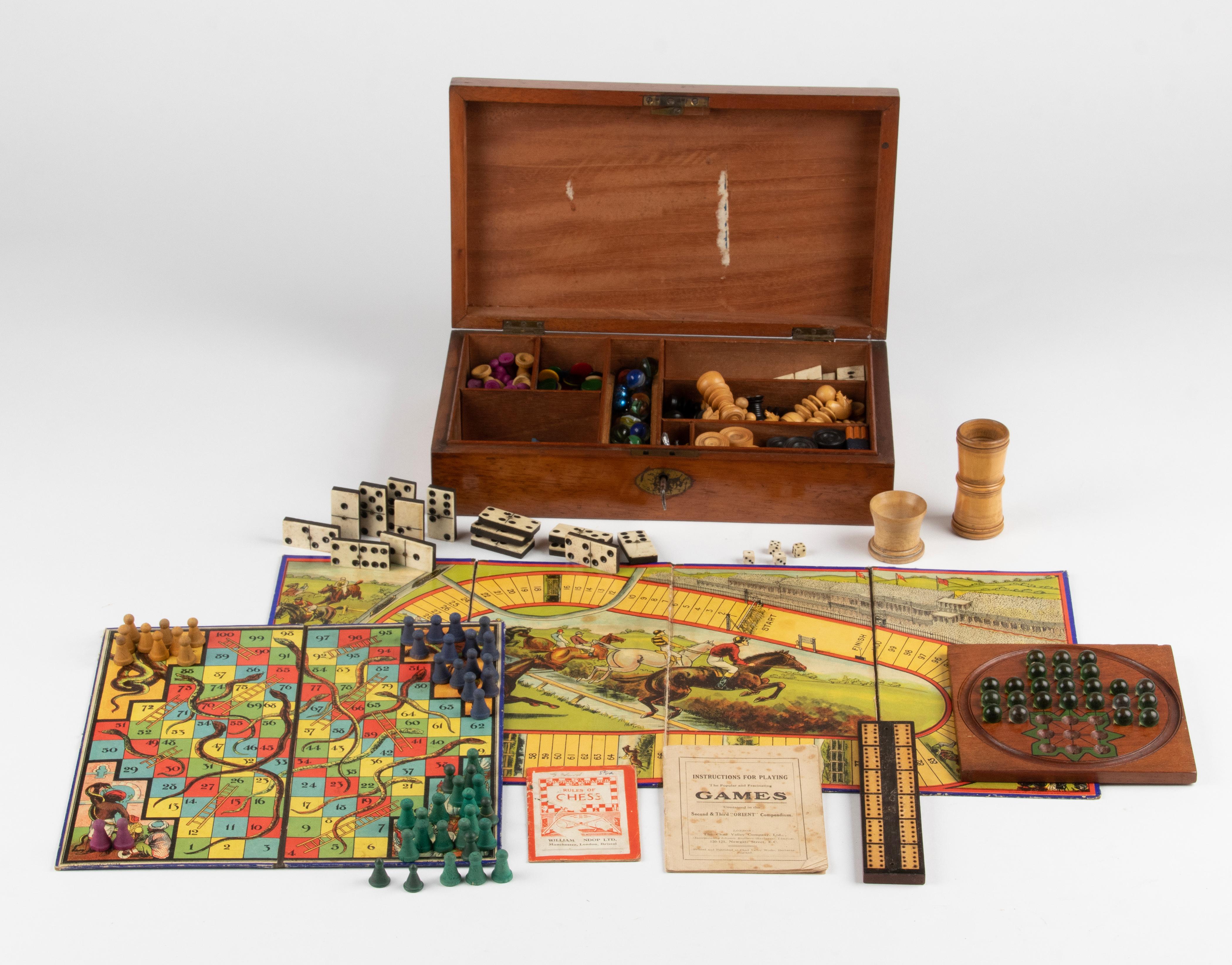 Lovely antique game box, made of mahogany. 
The box contains several games, with many bits and pieces. Not all complete. 
It is obviously that there has been played with the games, but overall you can say that the set is in good condition. 
