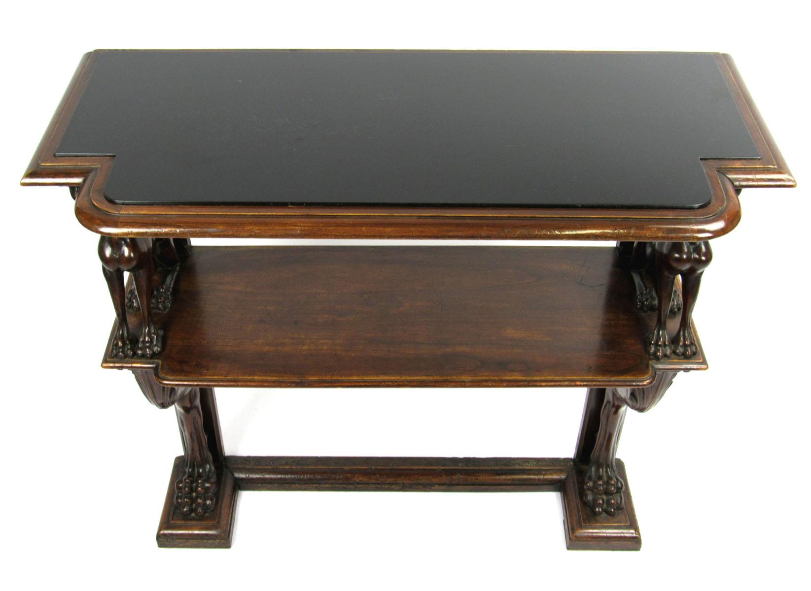 Late 19th century English mahogany console server with ebonized top above gryphon supports on the upper shelf and lion's legs with carved floral on the hip on the lower supports.