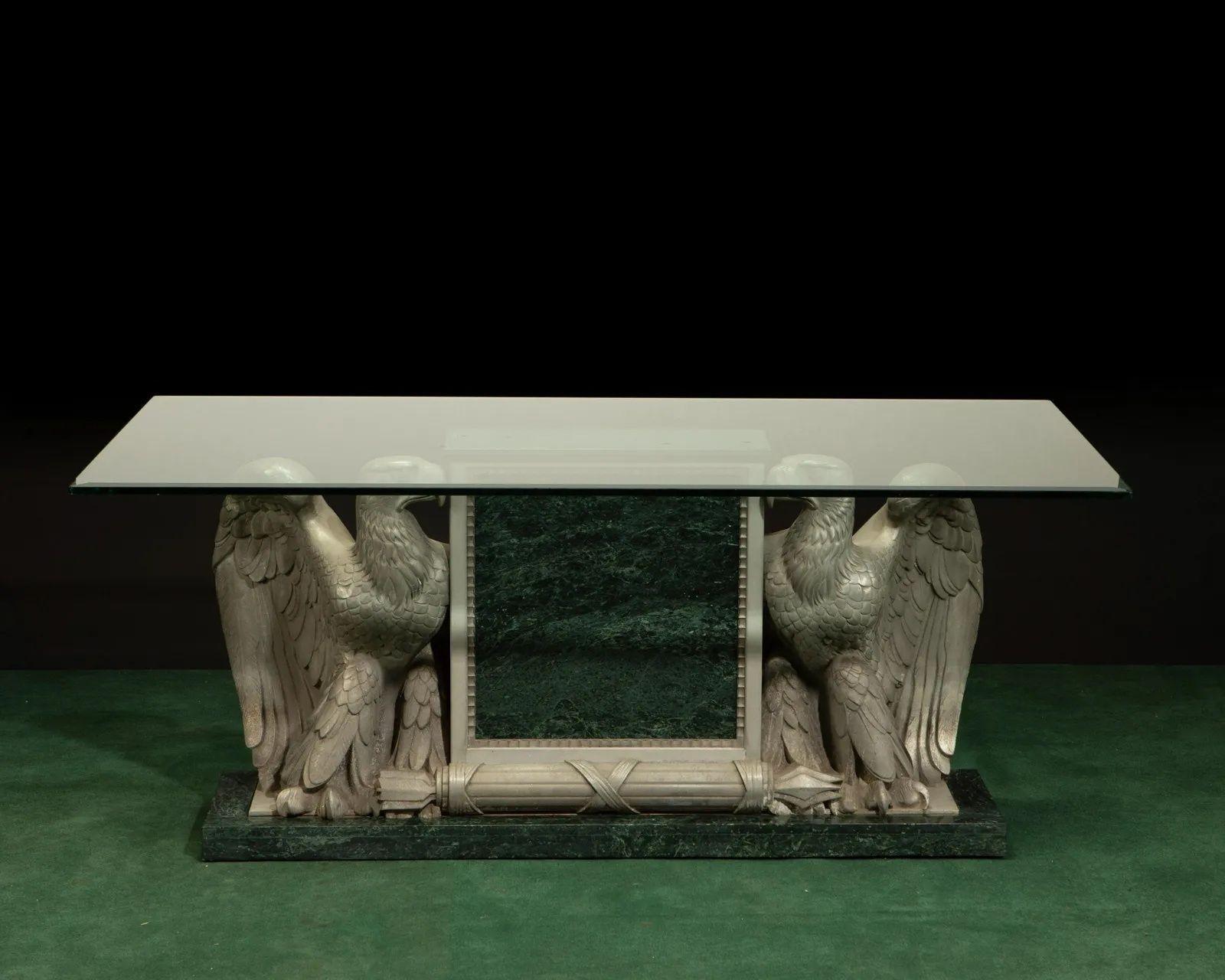 Late 19th century.
The double-eagle galvanized/zinc metal base with marble trim and glass top.
Created in England from a vintage architectural double-eagle element. 
 
 
Dimensions:
 
29