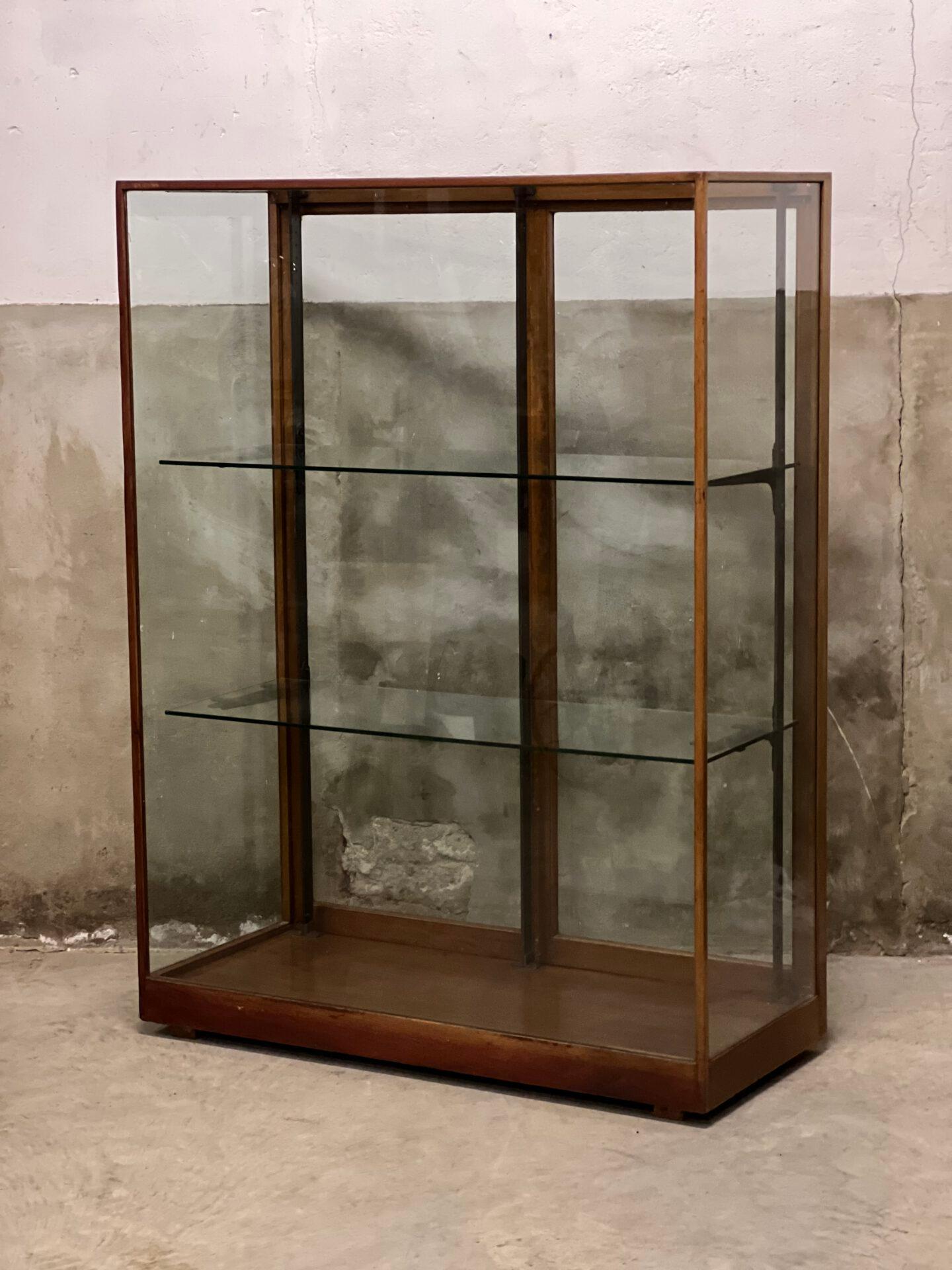 Antique English museum display case, shop display case made of solid mahogany with thick glass and thick glass shelves. In beautiful condition with forged glass carriers and frame. Can have a lot of weight and therefore perfect for displaying your