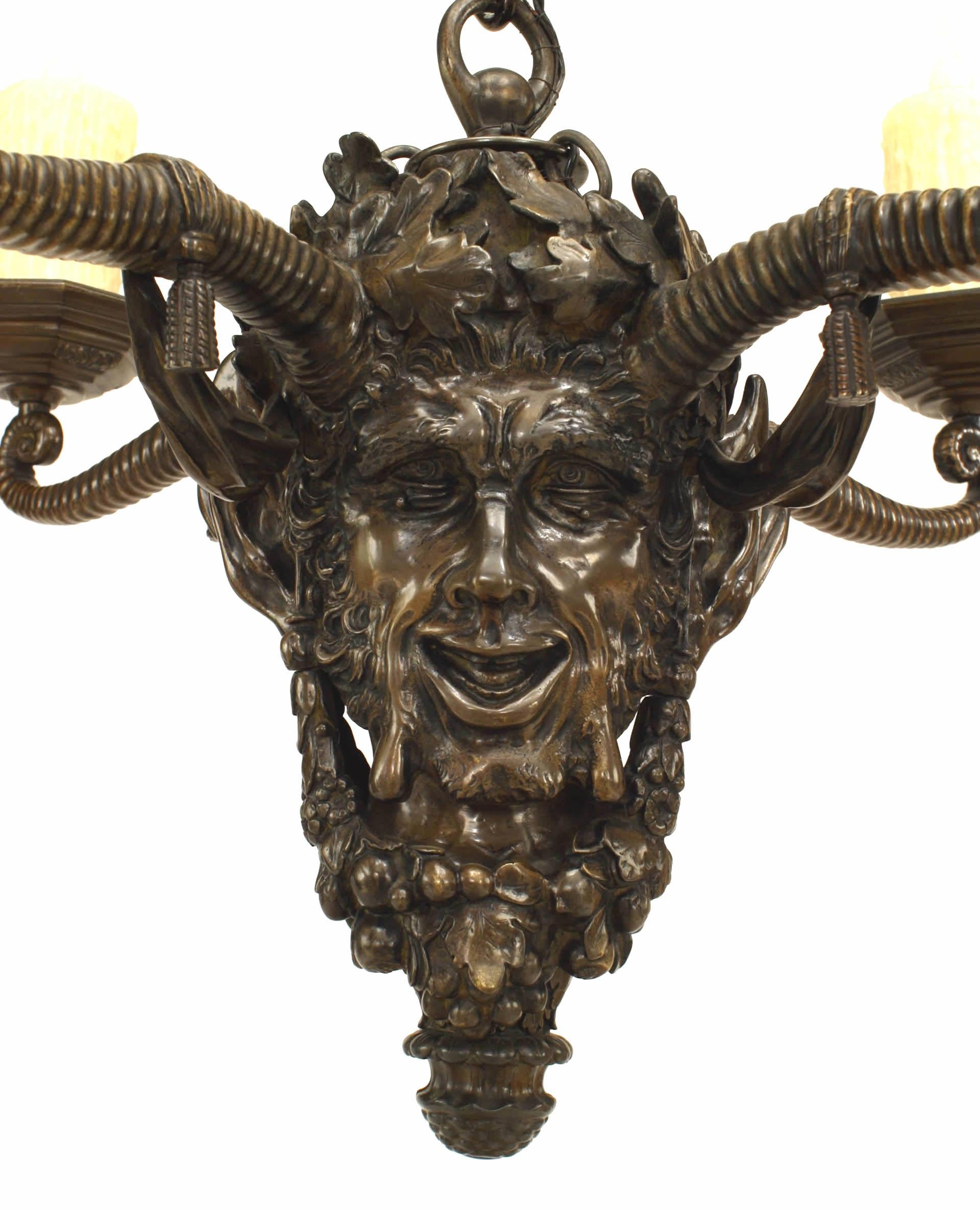 English Victorian-style (late 19th Century) bronze chandelier of mythological head form festooned with oak leaf crown and garlands with 4 fanciful horn arms. (23