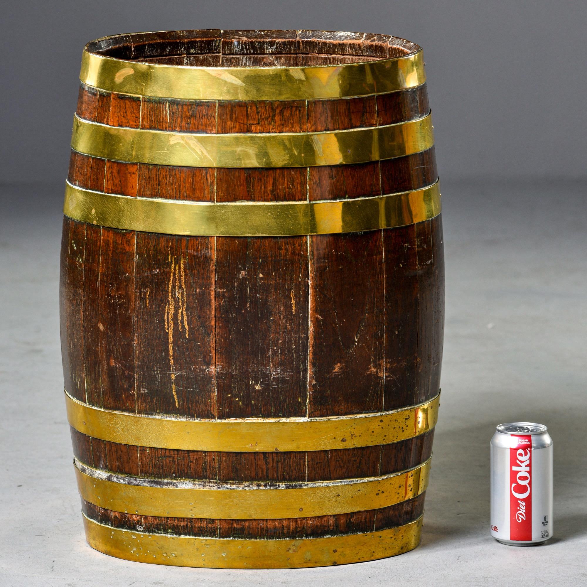 Tall, oval shaped oak barrel with six polished brass bands. Found in England, circa 1880s. Unknown maker. 

    
