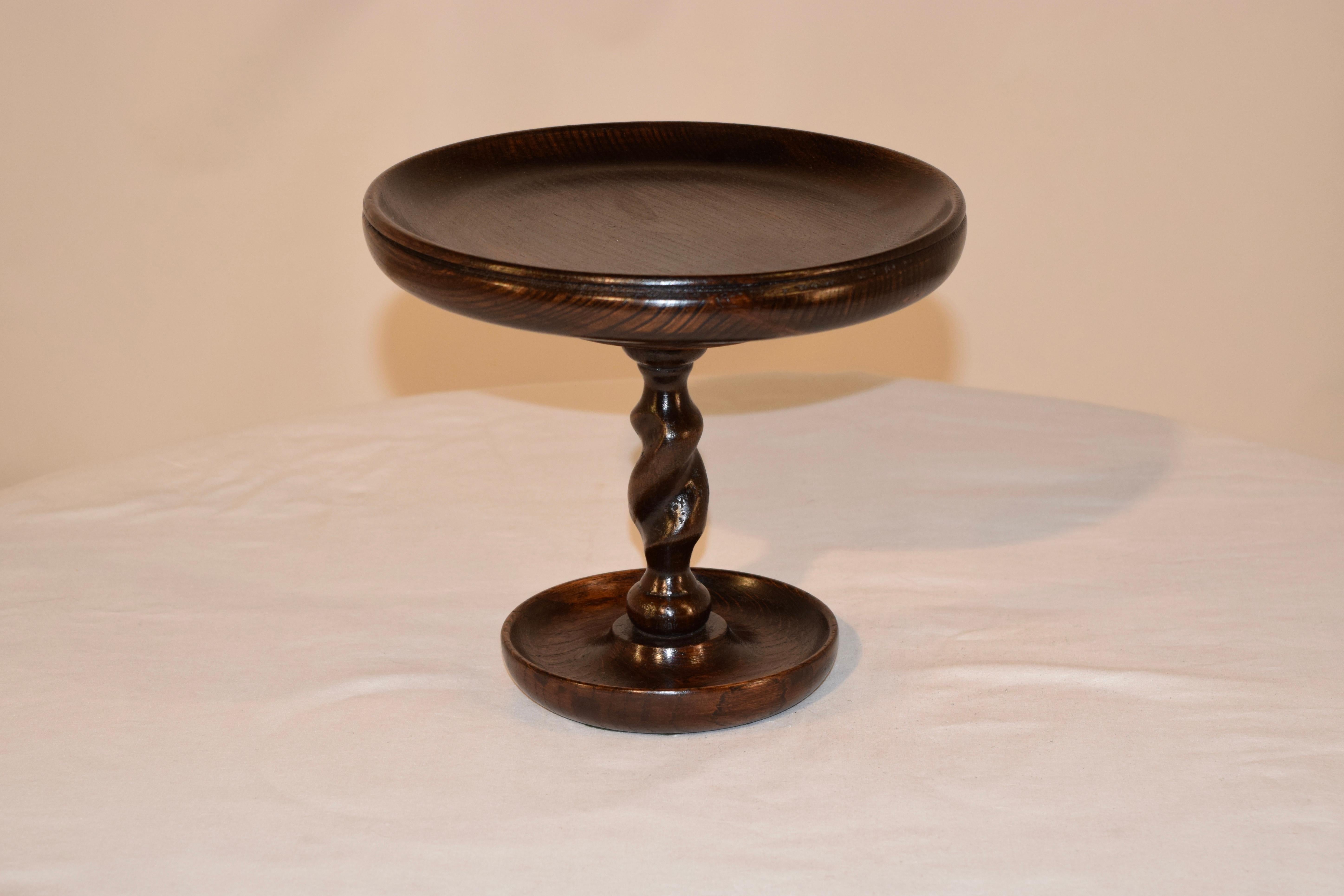 Late 19th century hand turned oak compote from England with a bowl shaped top which has a molded edge, supported on a hand turned barley twist column and hand turned dish shaped base.
