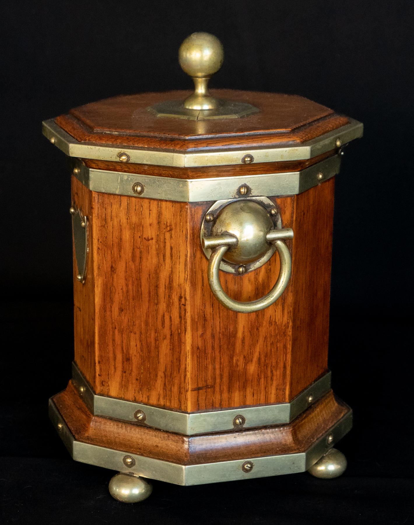 Late 19th century English Oak Octagonal Humidor With Silver Mounts. Complex octagonal form with moldings and silvered brass fittings. The base supported by small bun feet, two ring handles and a ball finial on the hinged top. The top is level and