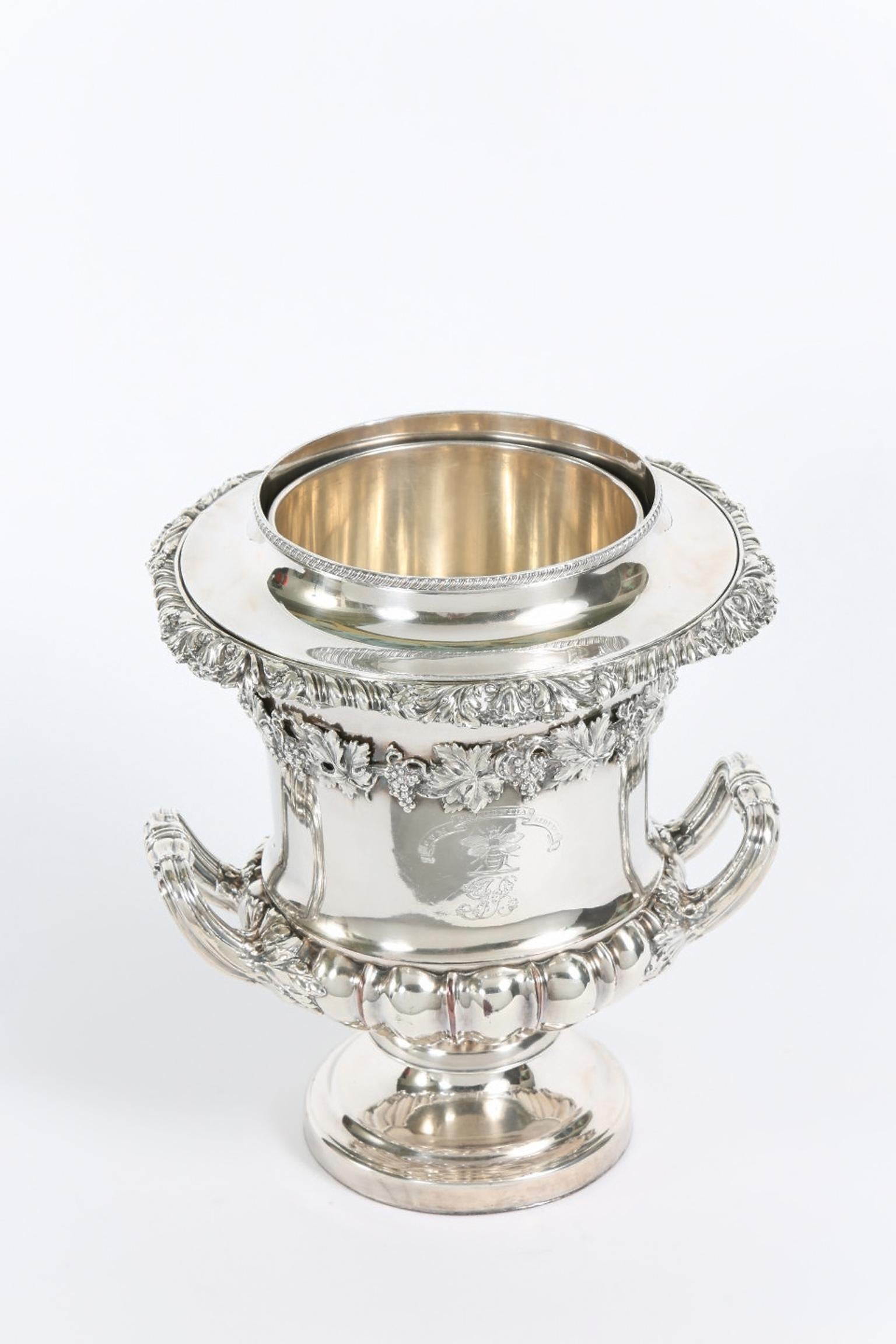 Impressive late 19th century English silver plated wine cooler with ice holding receptacle & exterior armorial crest design details. The cooler is in great antique condition with normal wear appropriate with age / use . The cooler measure about 10