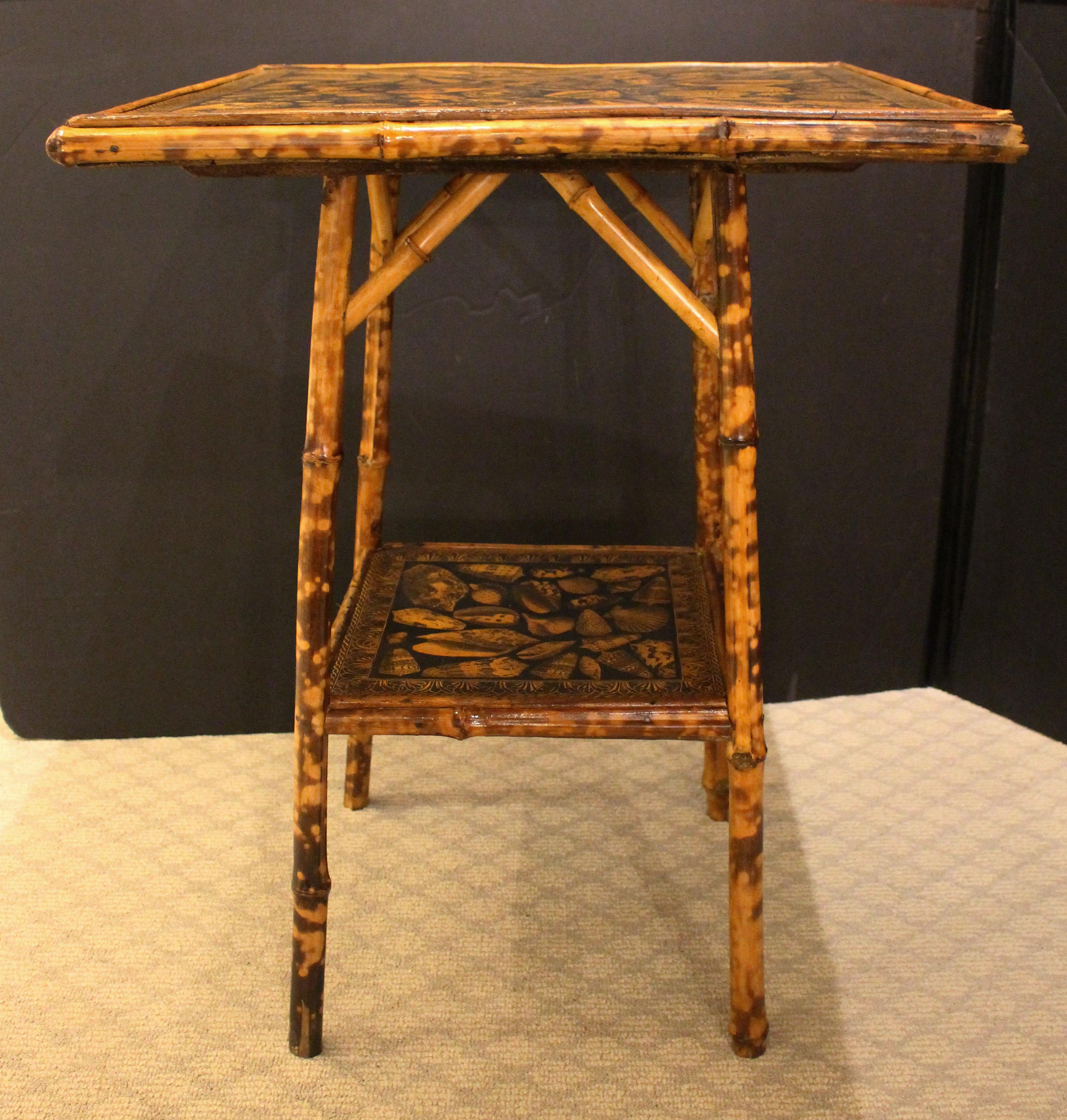 Late 19th century English 2-tier bamboo side table of large square size. Now decoupaged with shells & neoclassical borders. Well figured bamboo. 20.5