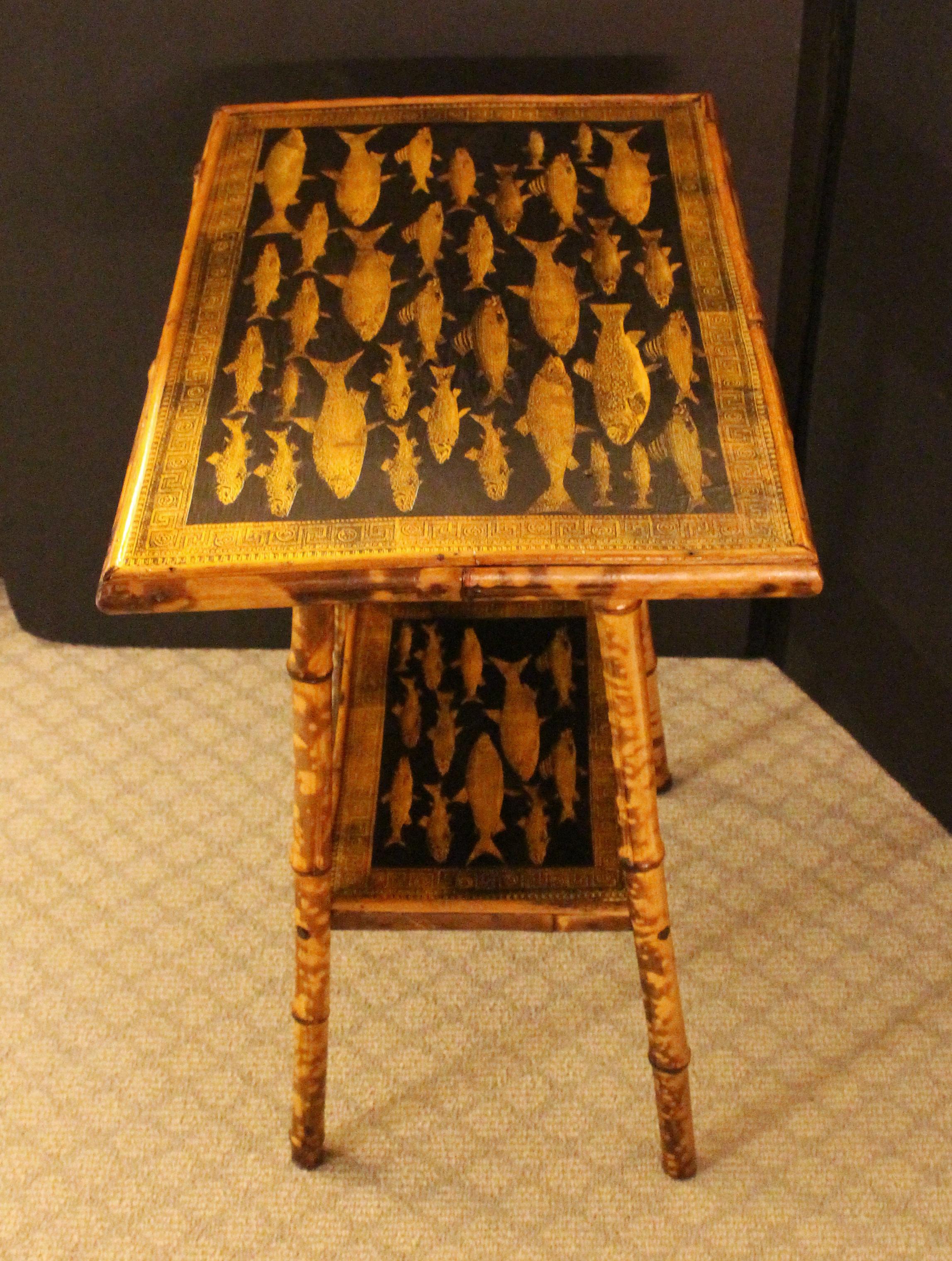 Late 19th century English 2-tier bamboo rectangular side table. The surfaces now decoupaged with fish & Greek key borders. Well figured bamboo.
20.5