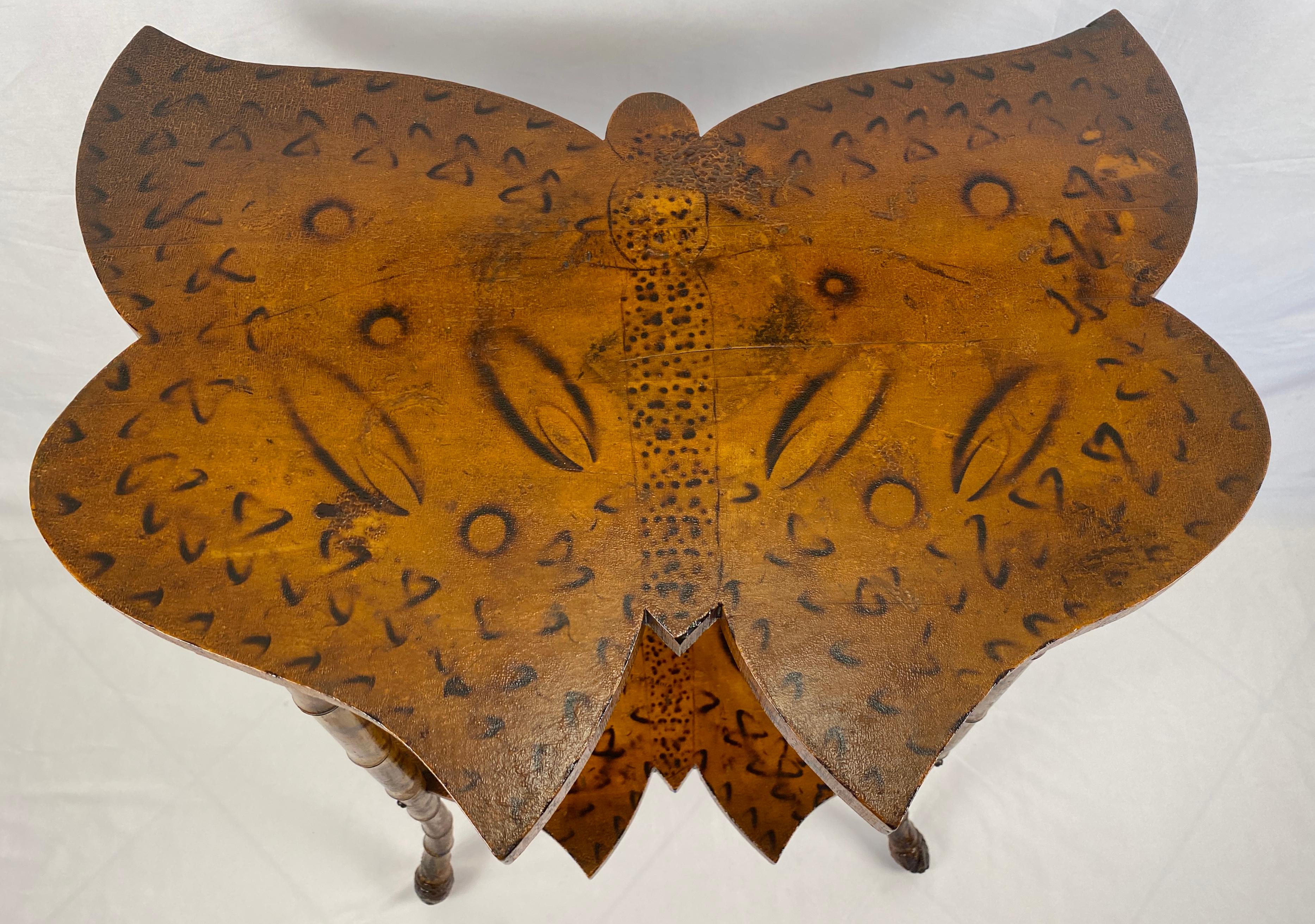 A captivating Late 19th Century Victorian English Bamboo Butterfly Side Table, a true testament to the elegance and craftsmanship of the era.

This versatile and exquisite side table features a distinctive butterfly-shaped top and lower shelf,