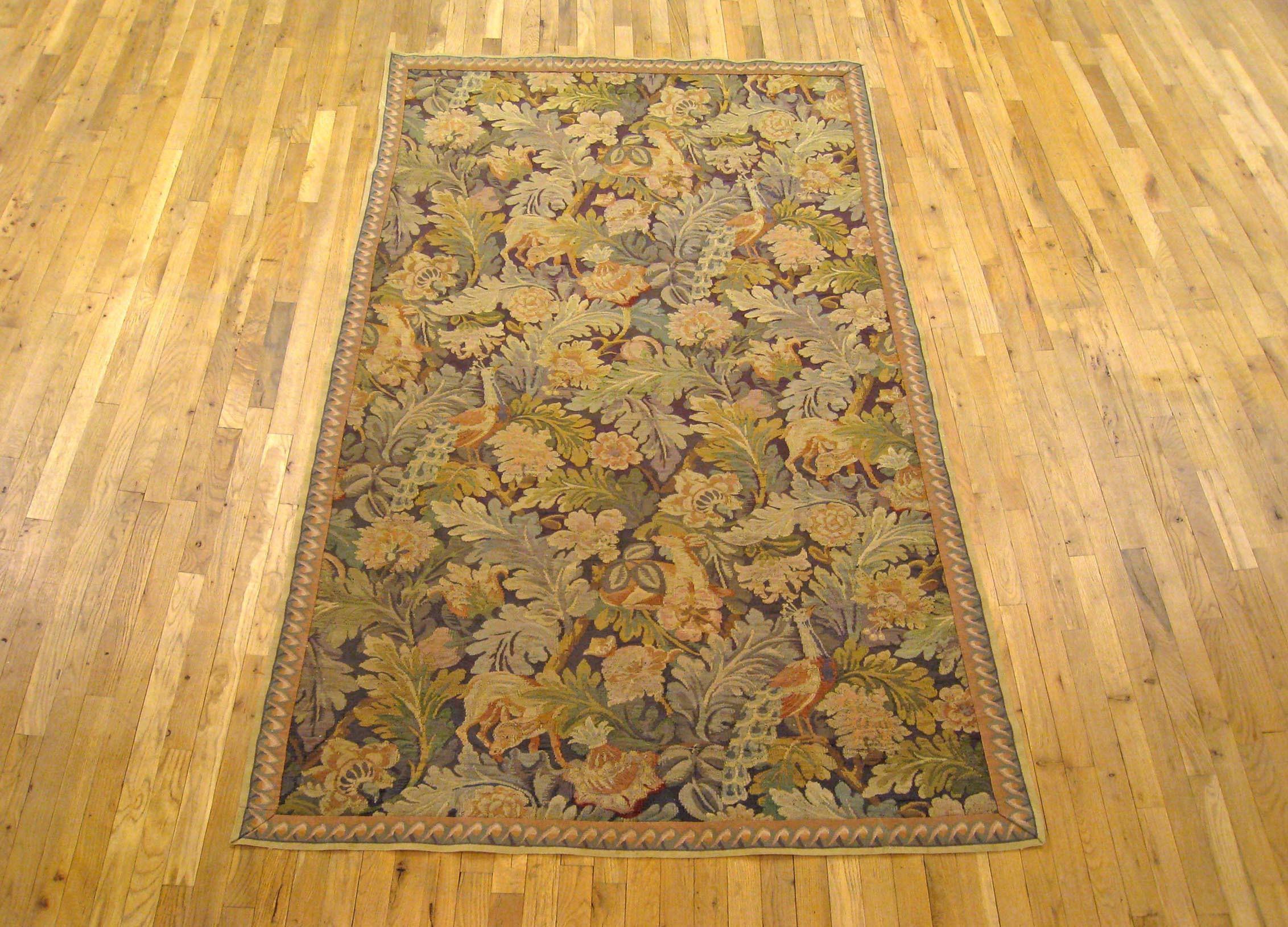 An English William Morris verdure tapestry from the turn of the 20th century, featuring several peacocks within a verdant setting of large leaves and floral sprays. Enclosed within an elegant ribbon-twist border. Measures: 8’5” H x 4’8” W.

This