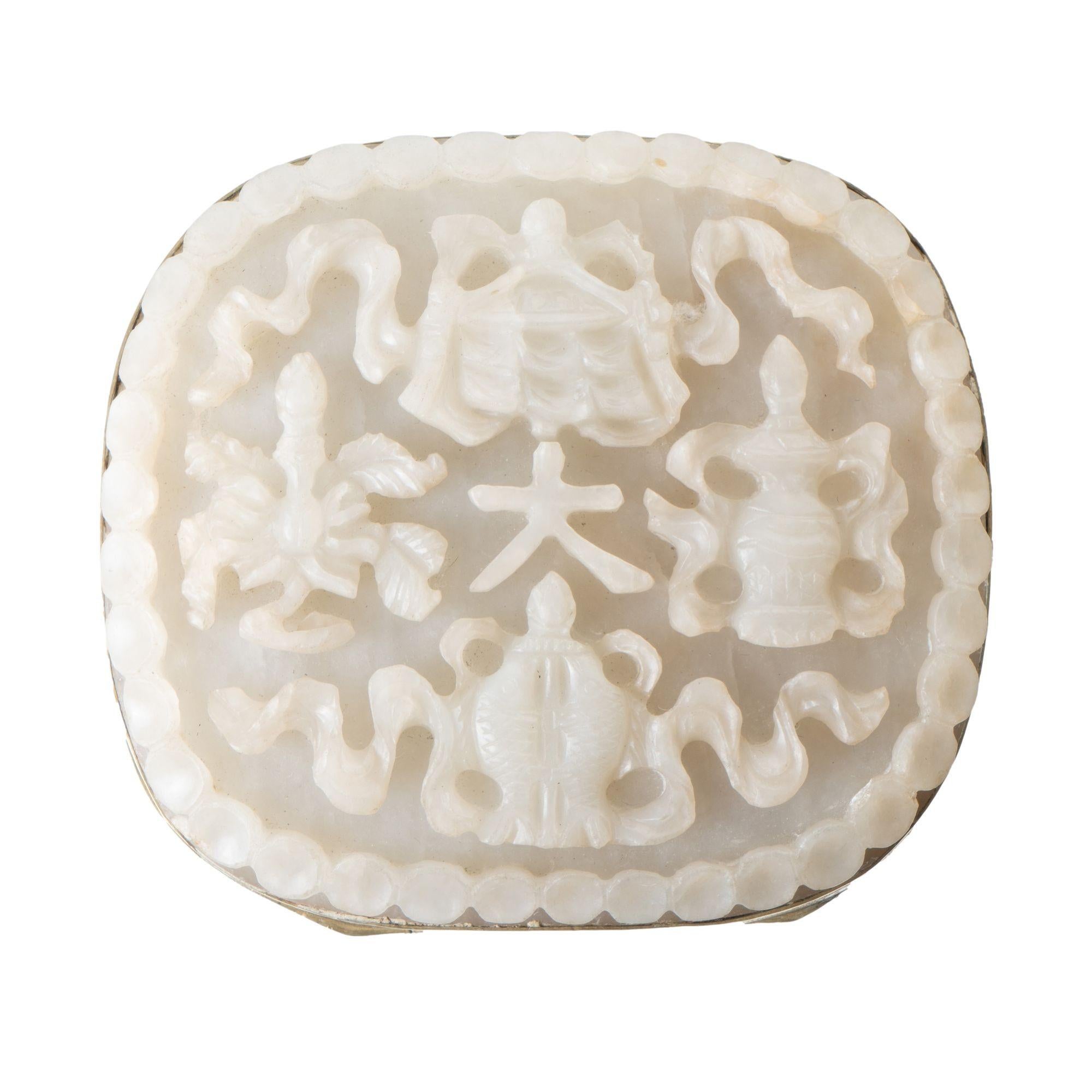Antique carved nephrite white jade from a ruyi, mounted to the hinged lid of a conforming brass box. The inside of the lid and outer surfaces are engraved with propitious symbols.
China, made for the American market, circa 1893.