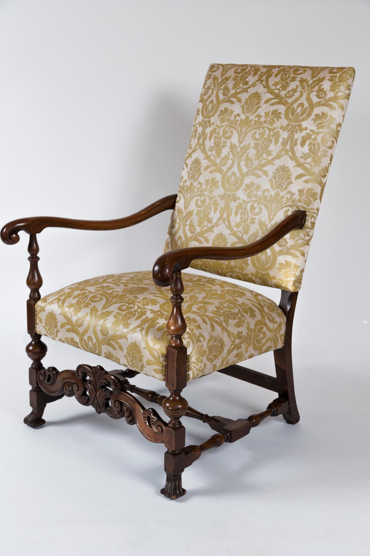 Late 19th century European Arm Chair. Tall back upholstered chair with lovely silk fabric in like-new condition. Finely carved front apron with stretcher. Elegant turned arms and legs with front claw shape feet.