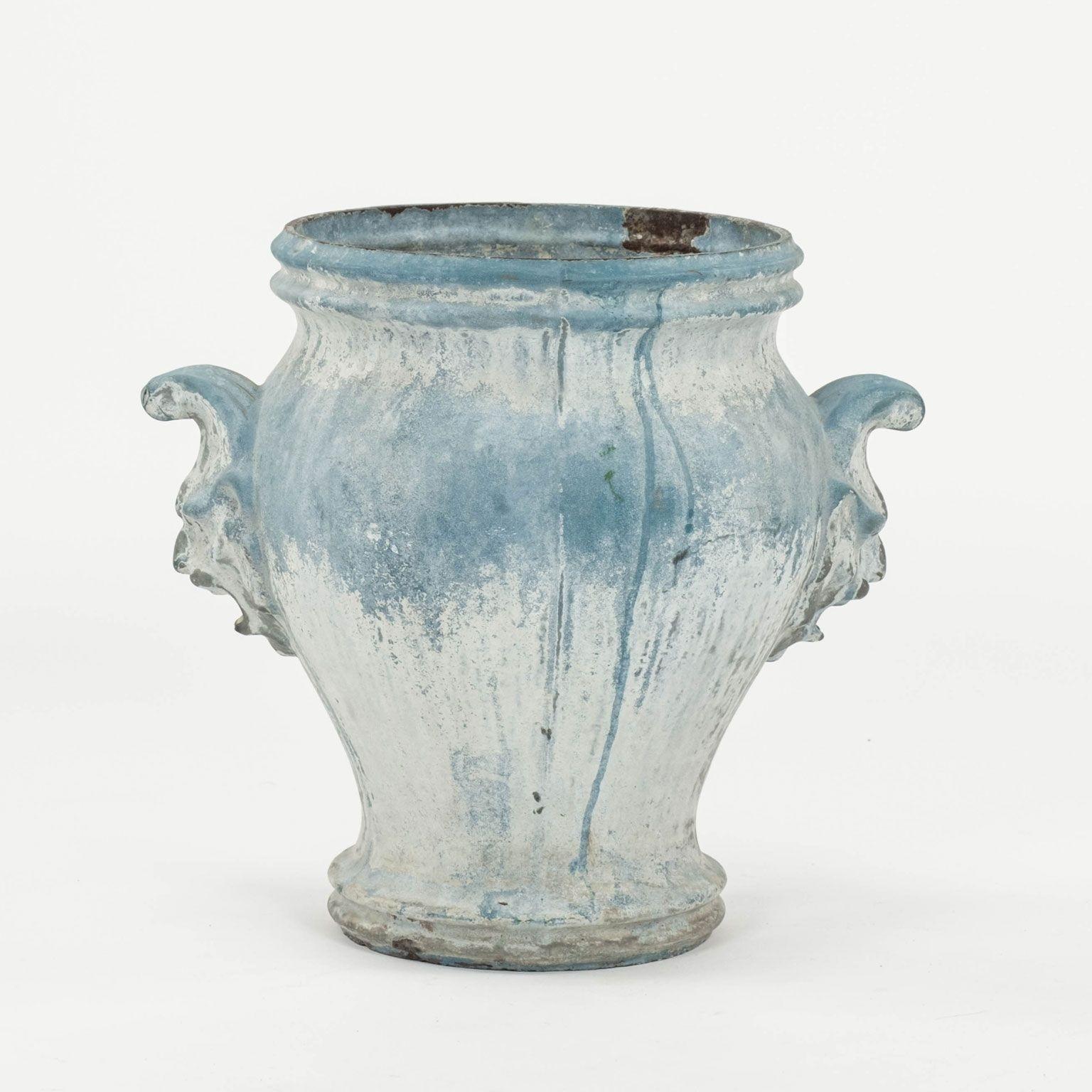 Late 19th century faded blue-color enamel cast iron urn with jester-faced mask handles. Heavy, fine quality cast iron. Made by E. Paris, marked 
