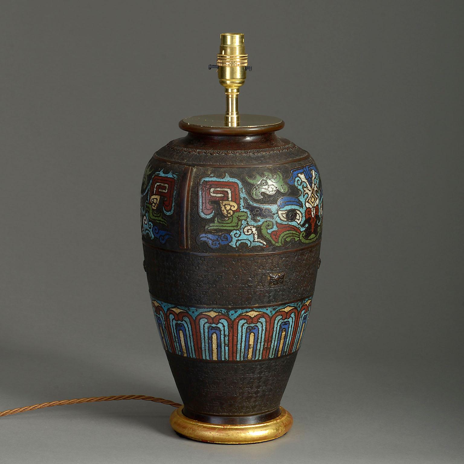 A late 19th century bronze vase, with finely cast decoration and enamelled inlay, mounted as a lamp with hand-turned water gilded base.

Dimensions refer to bronze vase and base only.

Shade not included.