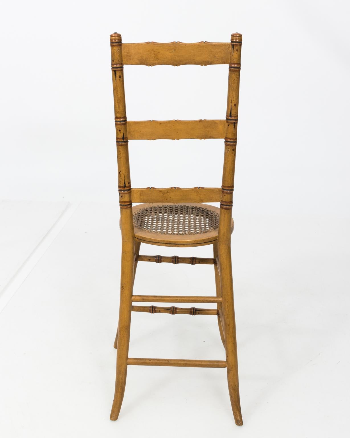 Late 19th century faux bamboo child's chair with ladder back and cane woven seat.
