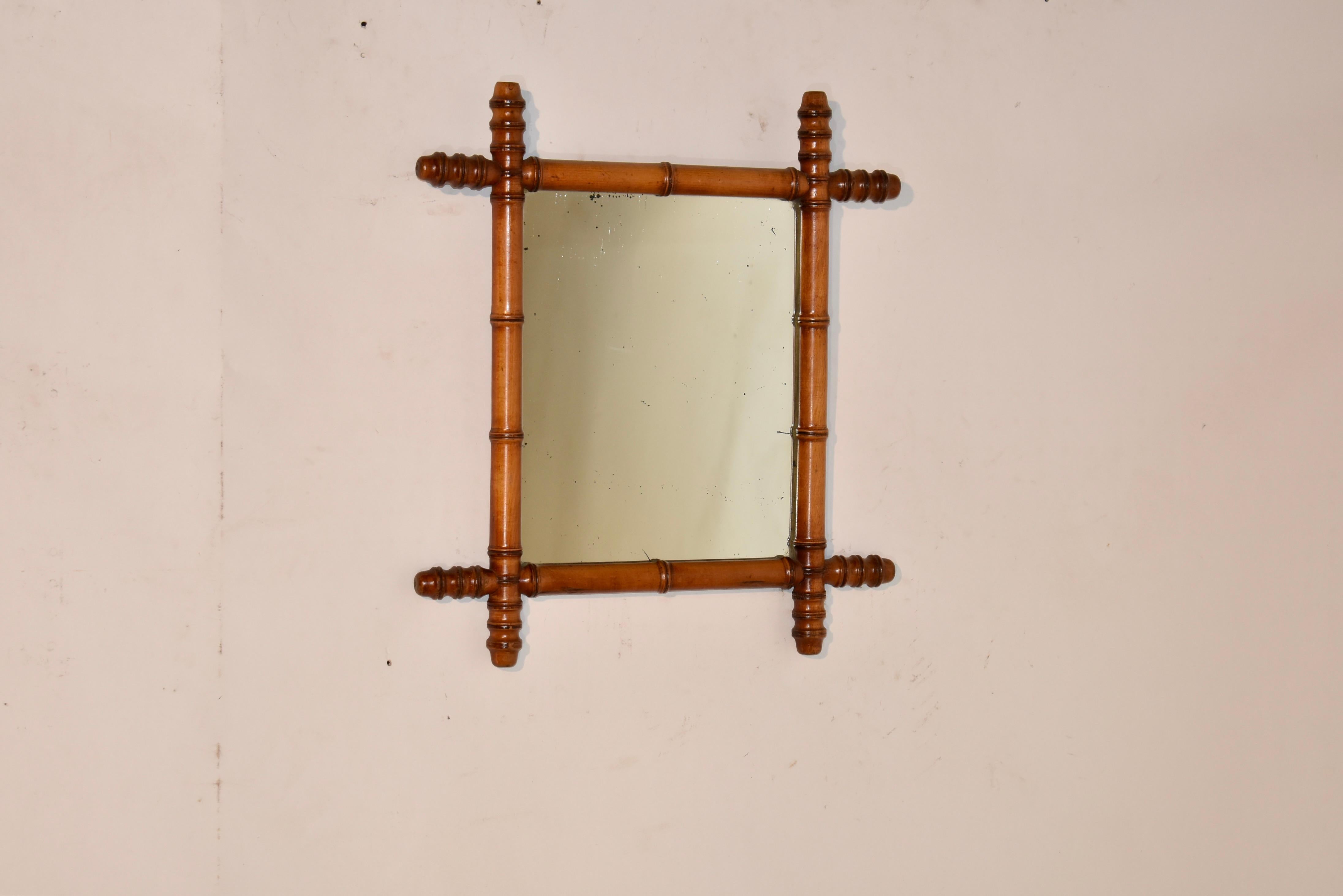 Late 19th century French faux bamboo turned mirror made from cherry.  The frame is turned to mimic bamboo, and is surrounding what appears to be its original mirror.  These are great looking, especially in a grouping.