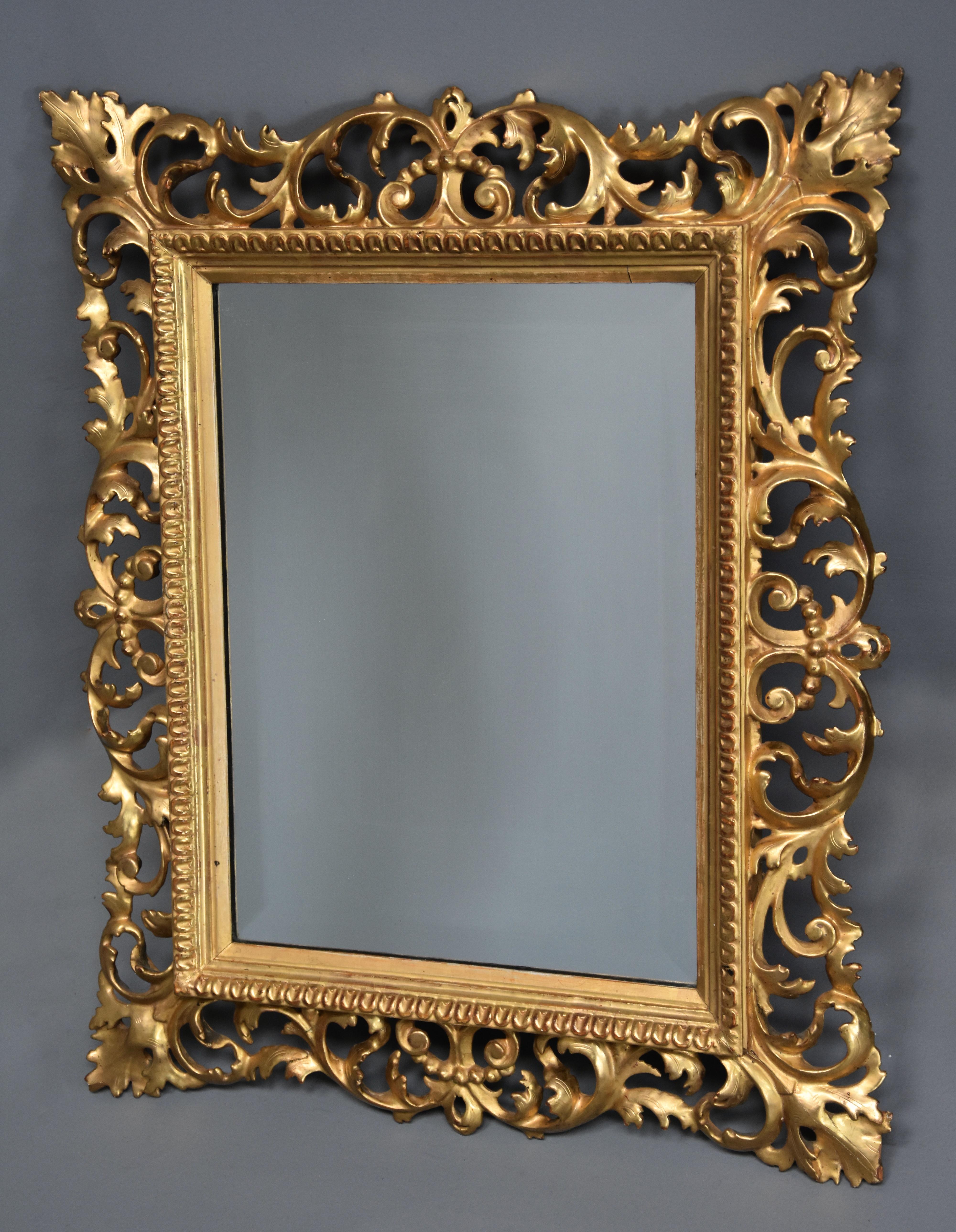 A late 19th century fine quality Florentine carved giltwood mirror.

This mirror consists of a finely carved gilt wooden frame of scrolling foliate decoration in very good original condition, the inner frame with a carved border design, the