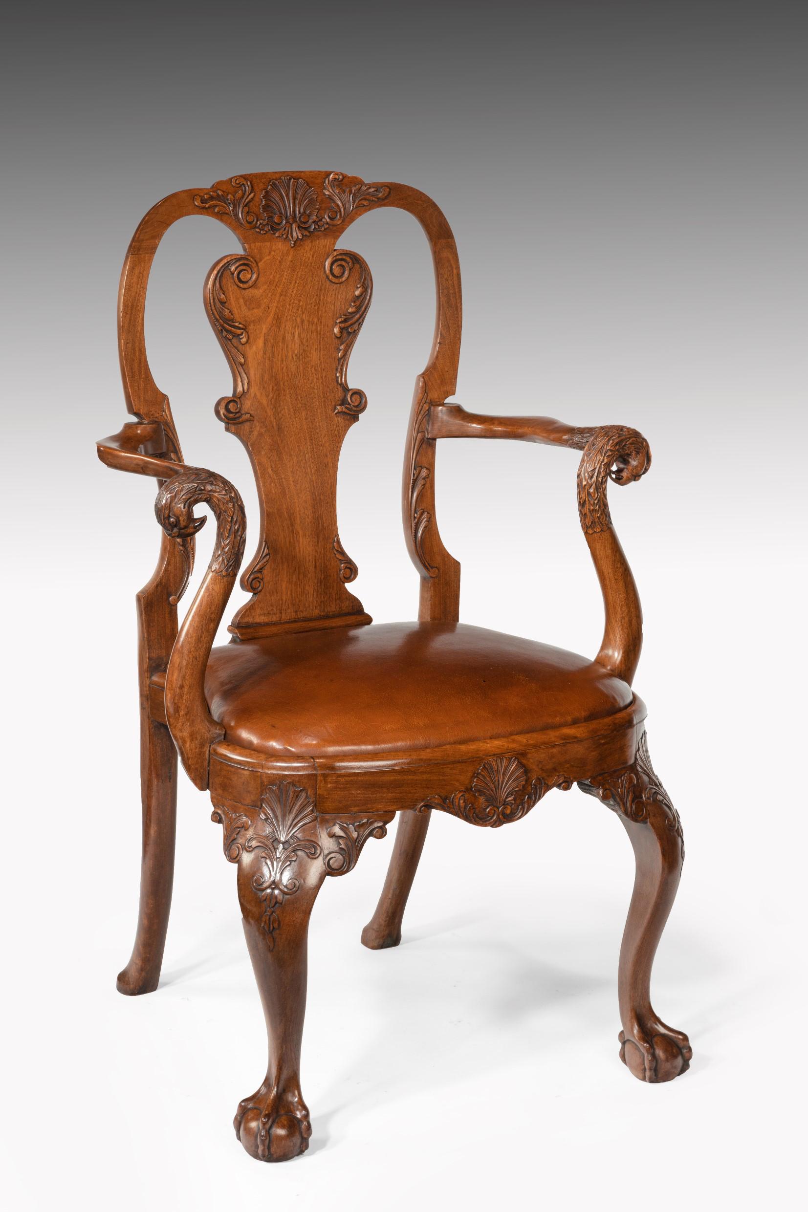 A finely carved and extremely good quality walnut vase back armchair / desk chair with leather drop in squab and eagle head terminals.

English, circa 1890-1900.

A fine example of excellent craftsmanship from the 1900s, this chair has been