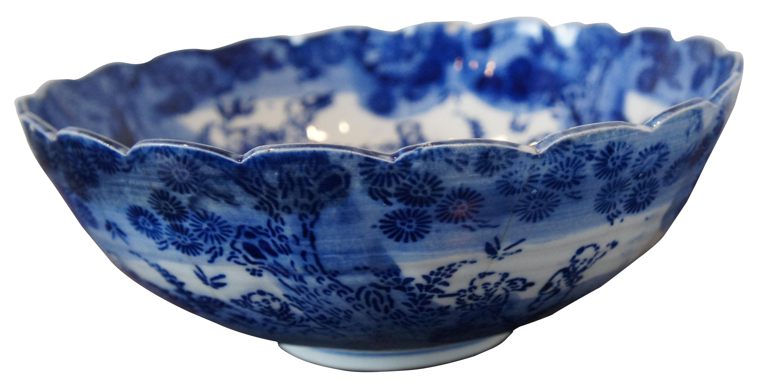 Antique turn of the century flow blue Chinese porcelain bowl with scalloped edge, decorated with figures in a forest around a phoenix center. Measure: 10