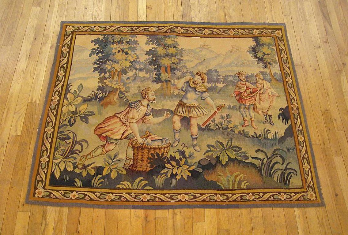A French historical tapestry from the late 19th century, envisioning an allegorical scene in which a king and his vizier are met by two of their soldiers as they prepare for battle. Enclosed within an elegant ribbon-twist border. Wool with silk
