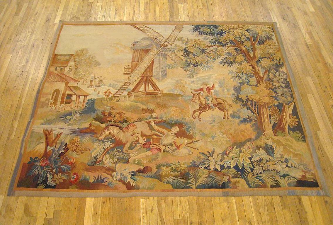 A French allegorical tapestry from the late 19th century, circa 1890, depicting Don Quixote knocked off his horse after unsuccessfully tilting at a large windmill, with his squire, Sancho Panza coming to his aid. Wool with silk inlay. Excellent