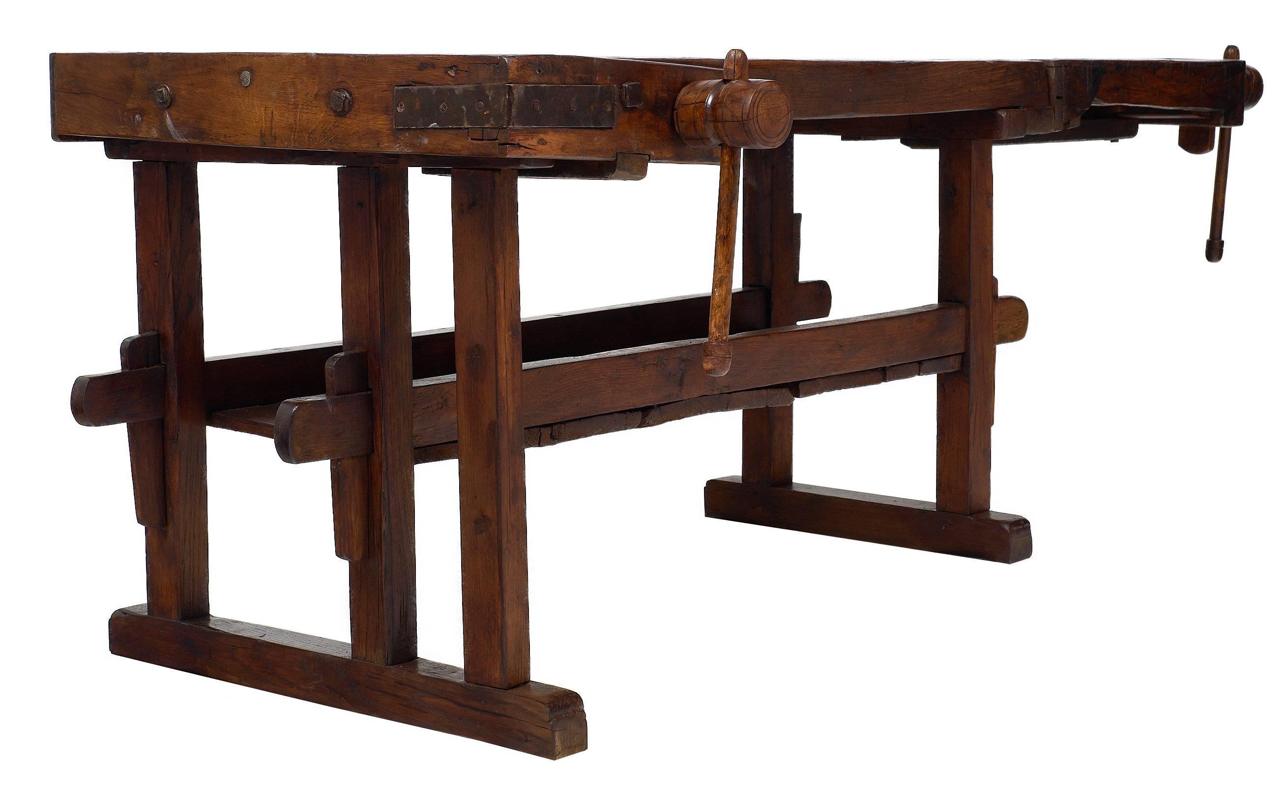 French antique work bench from Chamonix in the French Alps. This rare and authentic piece was used in the Haute Savoie capital to carve and shape wooden skis by hand. The bench shows great patina, and it features two vises and a shelf. The vises are