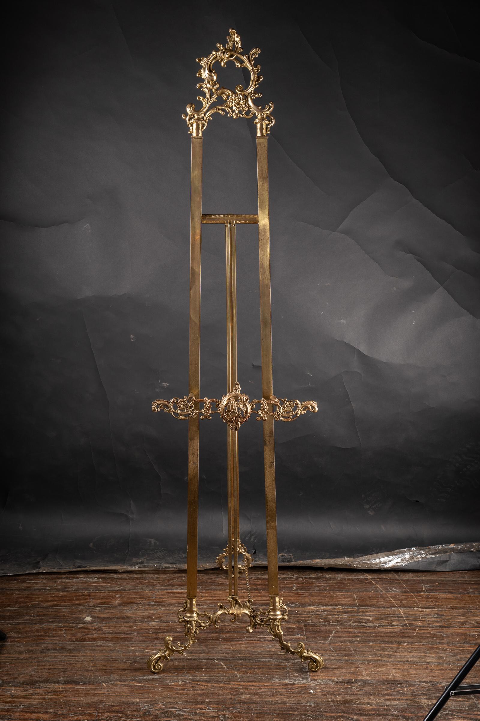 French Art Nouveau Solid Brass Easel with elaborate top, plain legs, and floriate decorations on the apron that holds the painting.  The legs also have floriate decorations in solid brass, on each leg.