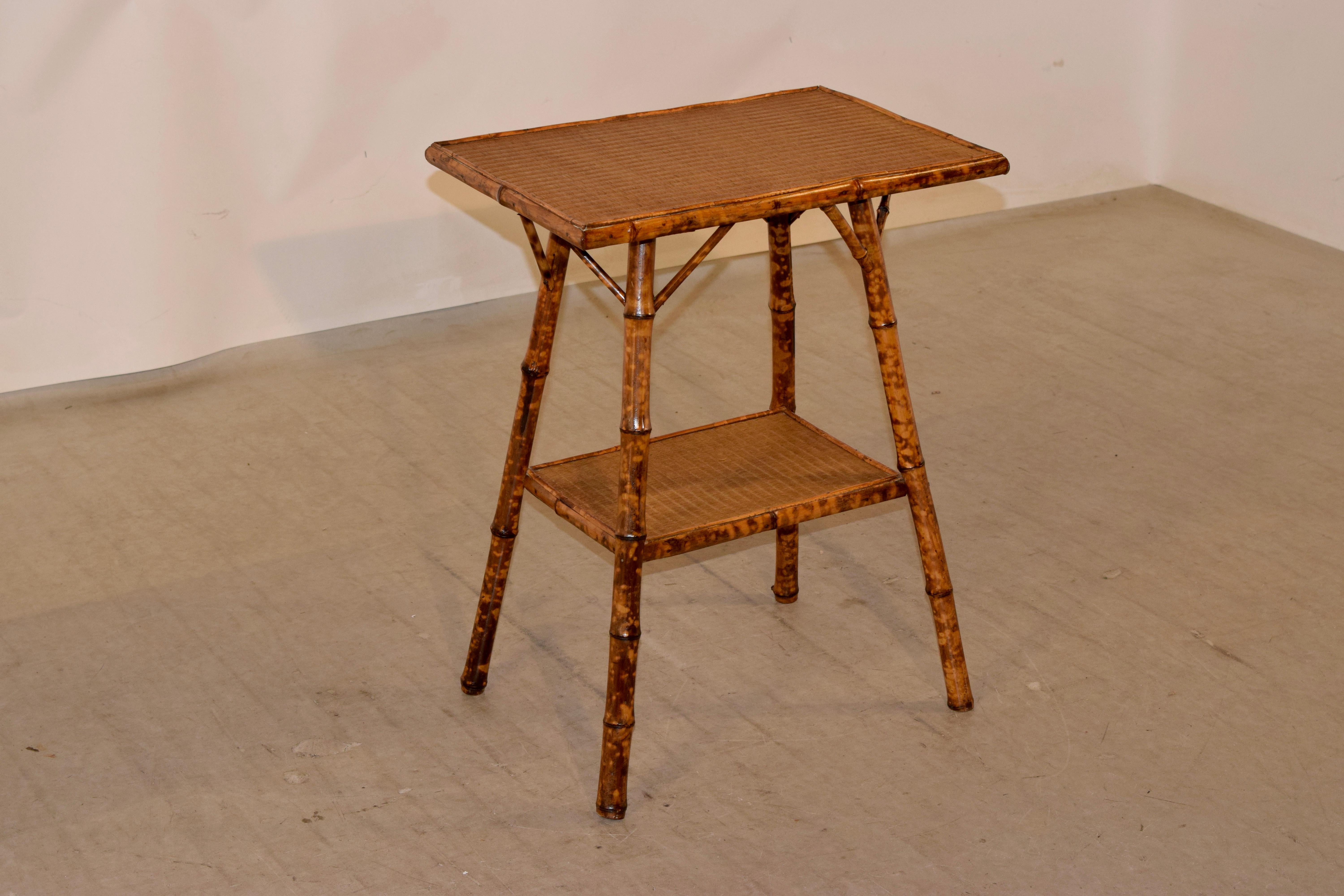 Late 19th century tortoise bamboo side table from France with a rush covered top and lower shelf.