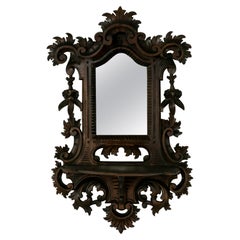 Antique Late 19th Century French Black Forest Hand Carved Walnut Wall Mirror with Shelf