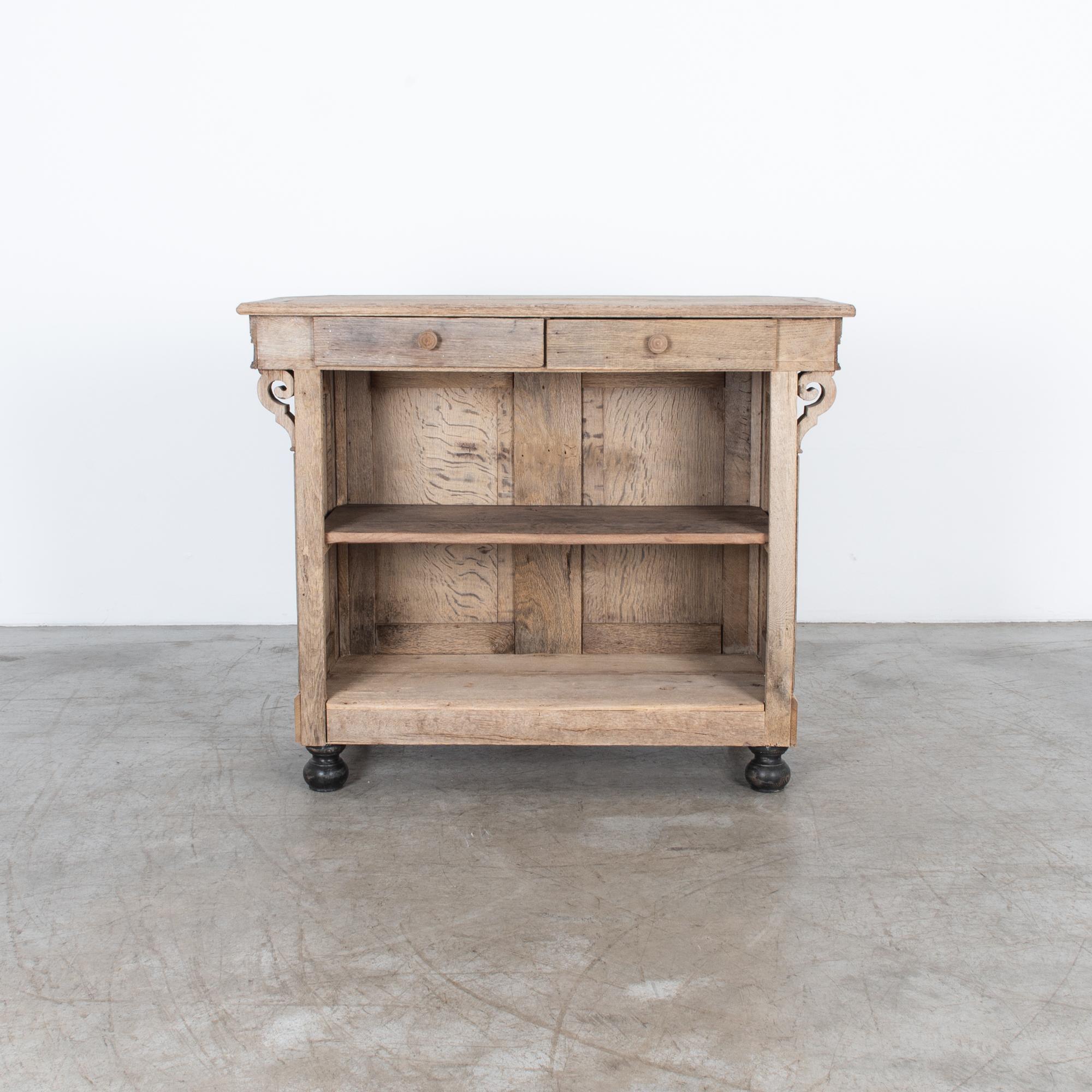 From France, circa 1880. This oak bar counter has been restored in our atelier, removing the fading finish, and polishing with oil and wax to highlight the natural beauty of the wood grain and the textured patina of time. This charming small bar