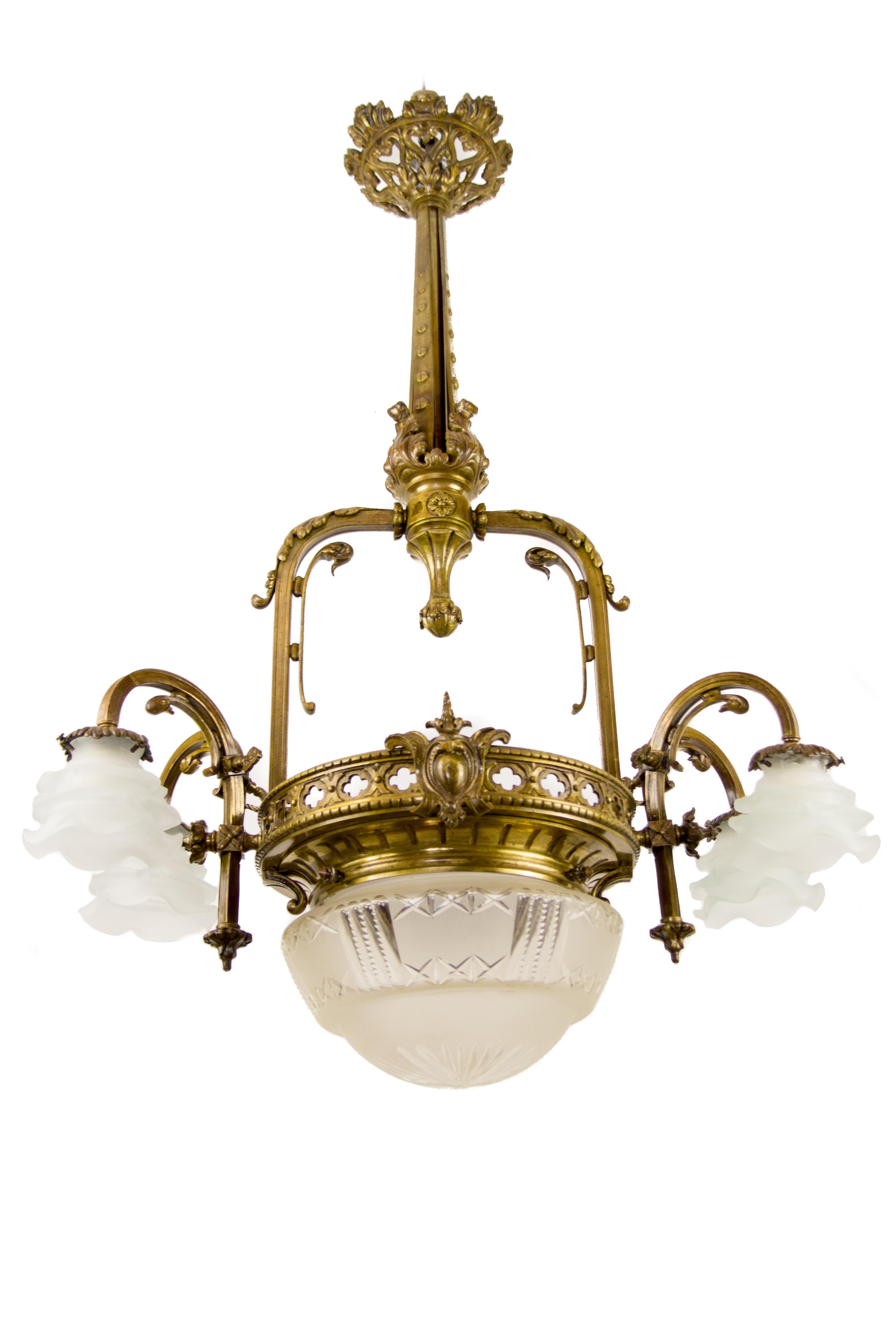 Late 19th-century French Victorian-style electrified gas five-light chandelier. Four bronze arms, each with a socket for the B22 size light bulb and floral-shaped, frosted glass lampshade (newer shades). The bottom center with the original cut glass