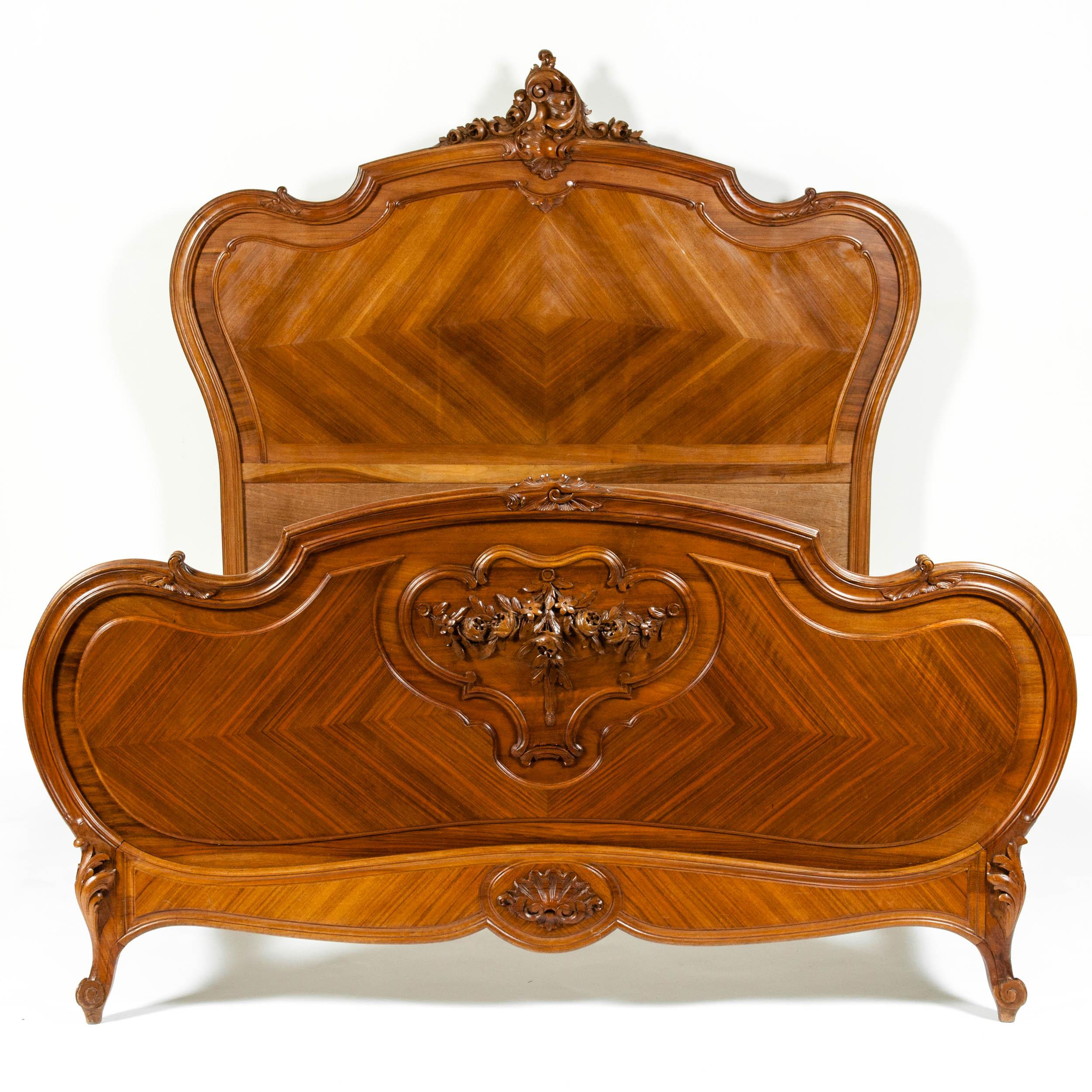 Late 19th century French hand carved walnut and burl walnut with design detail bed. The bed is in excellent sturdy antique condition with  wear appropriate with age / use. The measure 79 inches length x 68 inches width x 65 inches high.
  